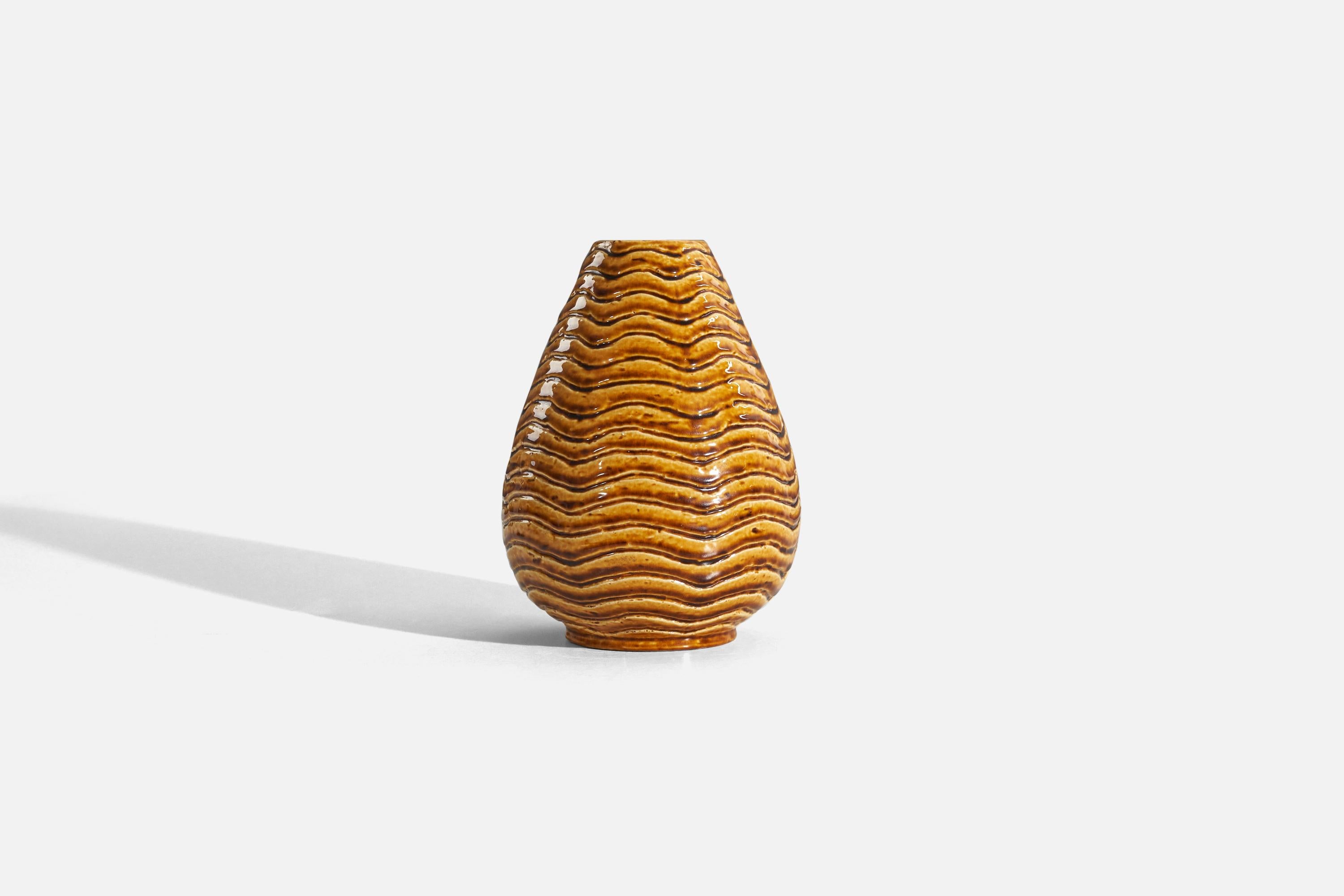 An orange, glazed stoneware vase designed by Gunnar Nylund and produced by Rörstrand, Sweden, 1940s. 


