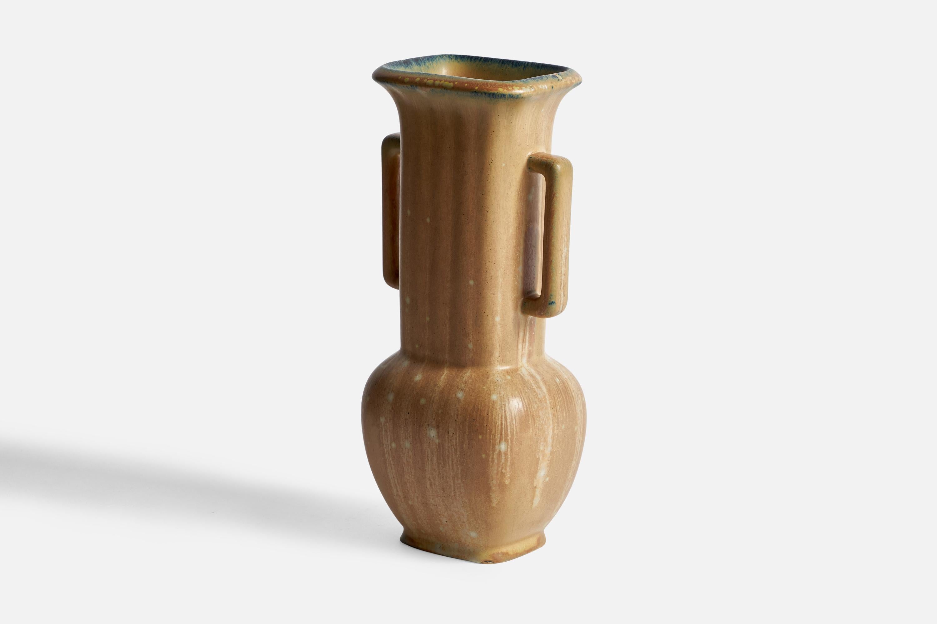 A beige-glazed fluted stoneware vase designed by Gunnar Nylund and produced by Rörstrand, Sweden, 1940s.
