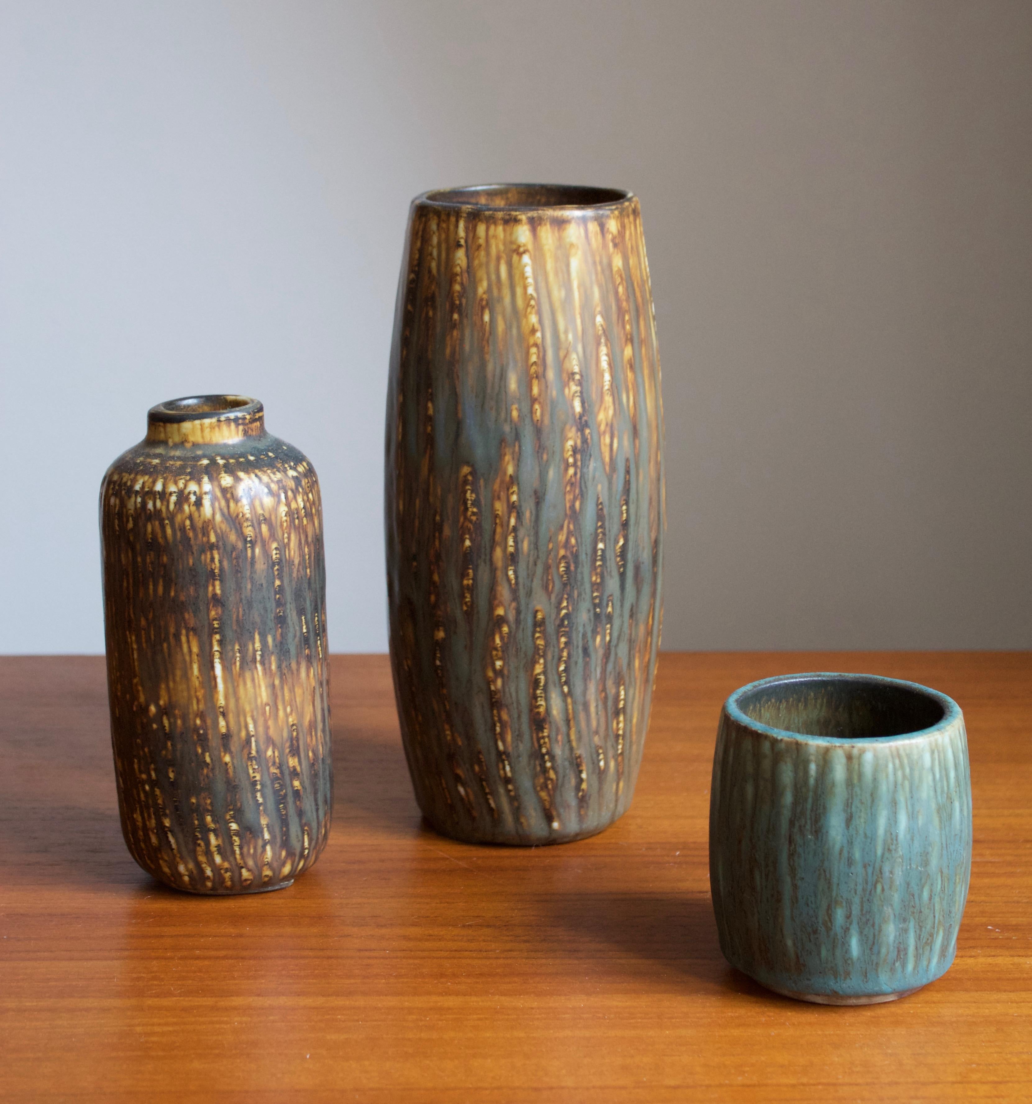 A set of three modernist vases by Rörstrand, Sweden, 1950s. Designed by Gunnar Nylund, (Swedish, 1914-1997). Signed.

Nylund served as artistic director at Rörstrands, where he worked 1931-1955. Prior to his work at Rörstrand he was a