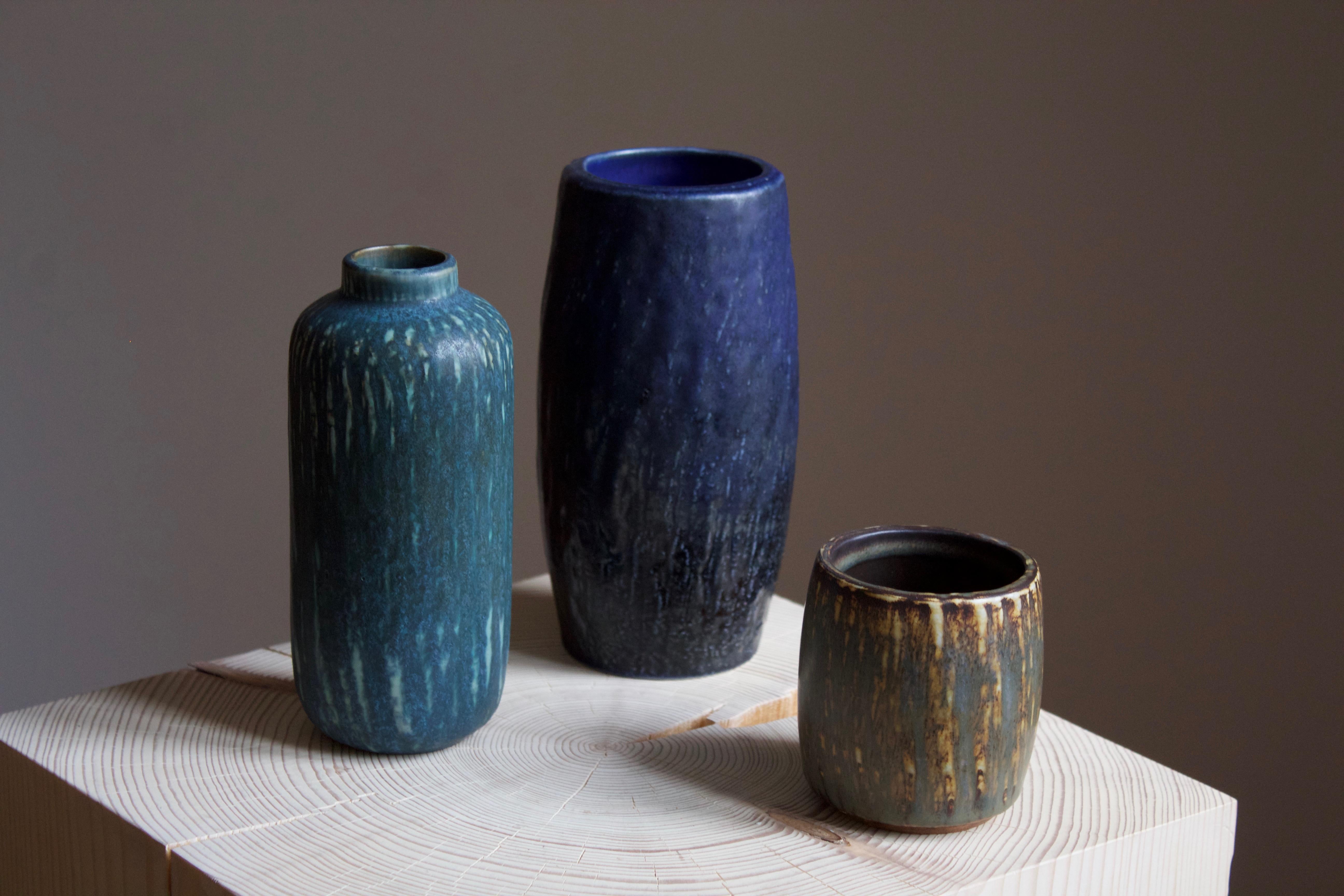 A set of three vases or vessels produced by Rörstrand, Sweden, 1950s. Designed by Gunnar Nylund, (Swedish, 1914-1997). Signed.

Nylund served as artistic director at Rörstrands, where he worked 1931-1955. Prior to his work at Rörstrand he was a