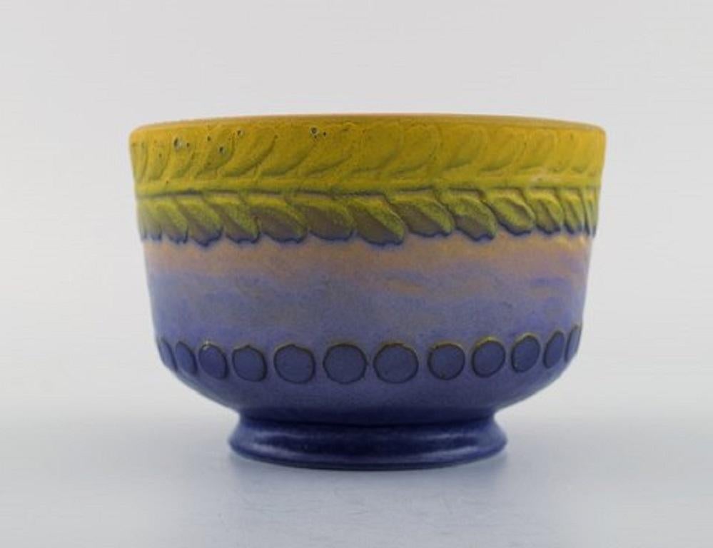 Gunnar Wennerberg for Gustafsberg. Antique unique bowl in glazed ceramics. Beautiful glaze in yellow and purple shades. Leaves and dots in relief. Dated 1906.
Measures: 12.5 x 8.5 cm.
Signed.
In excellent condition.