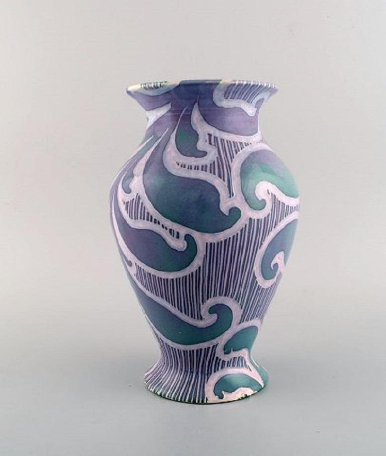 Gunnar Wennerberg for Gustavsberg. Antique unique Art Nouveau vase in glazed ceramics. 
Beautiful glaze in purple shades with foliage in relief. Dated 1902.
Measures: 25.5 x 16.5 cm.
Signed.
In excellent condition.