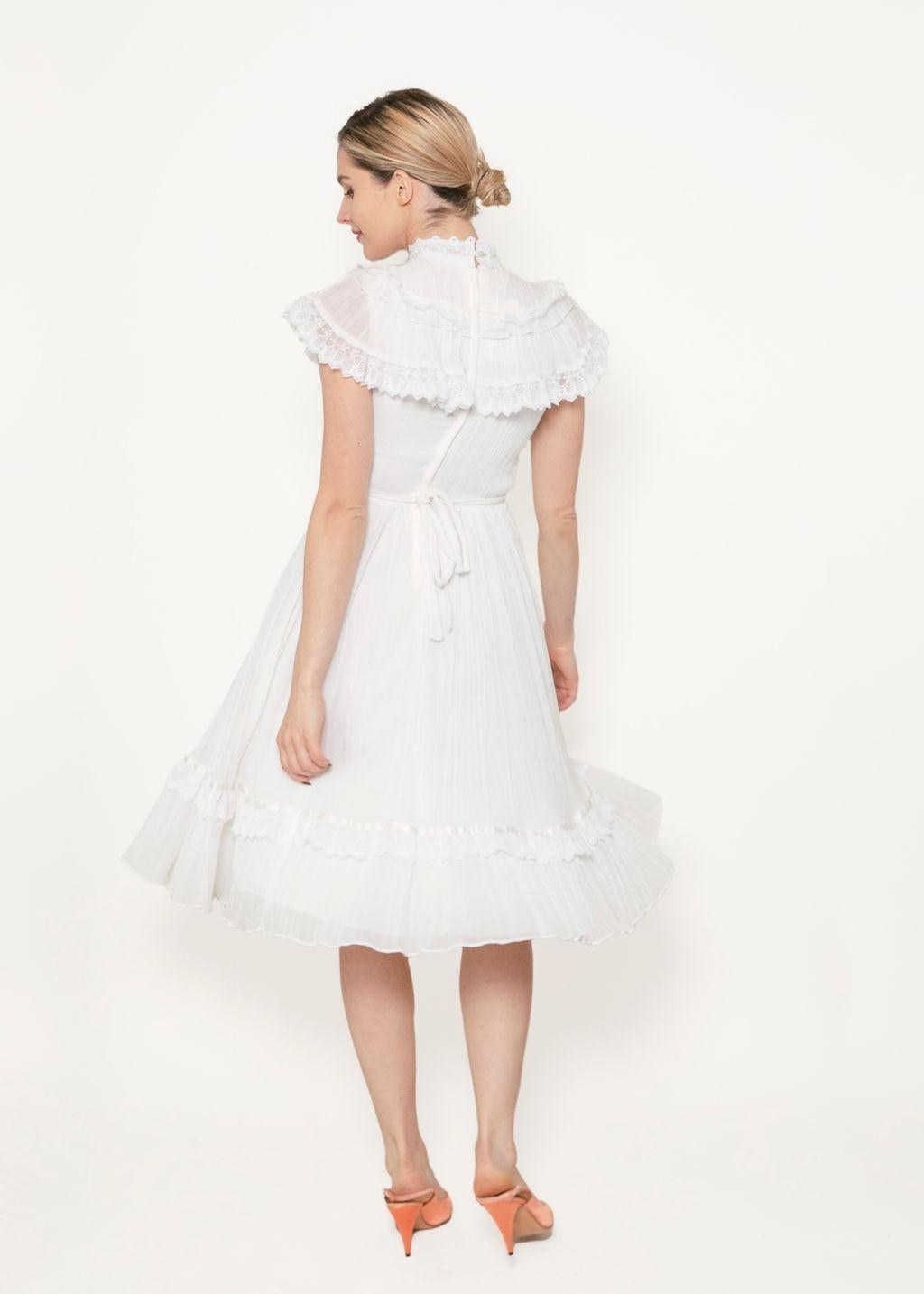 This Gunne Sax lace dress takes your wardrobe back to the Victorian era, with a fully lined, babydoll-style silhouette and a high ruffled neck. The rear zipper ensures a snug fit, perfect for creating a classic, timeless look. 

In great vintage