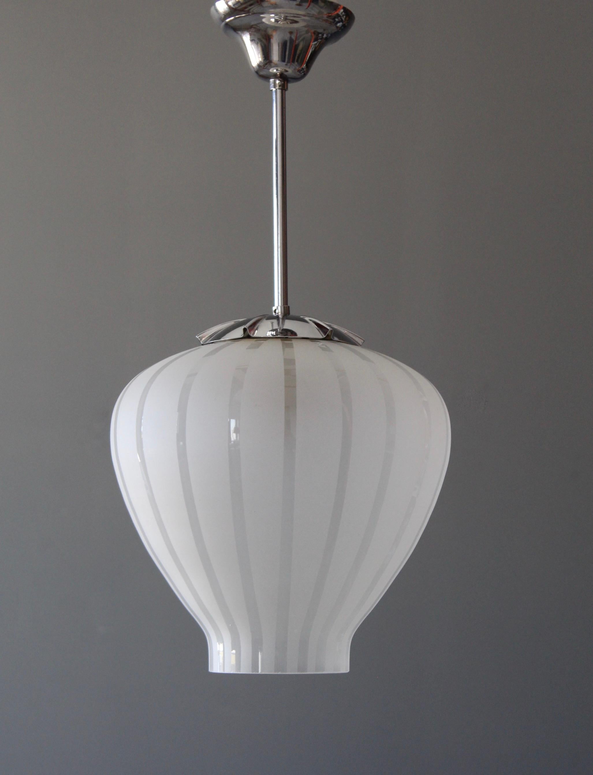 A pendant light. Design attributed to Gunnel Nyman, presumably manufactured by Orrefors, Sweden. Features frosted glass, metal. 

Height stated includes full drop.