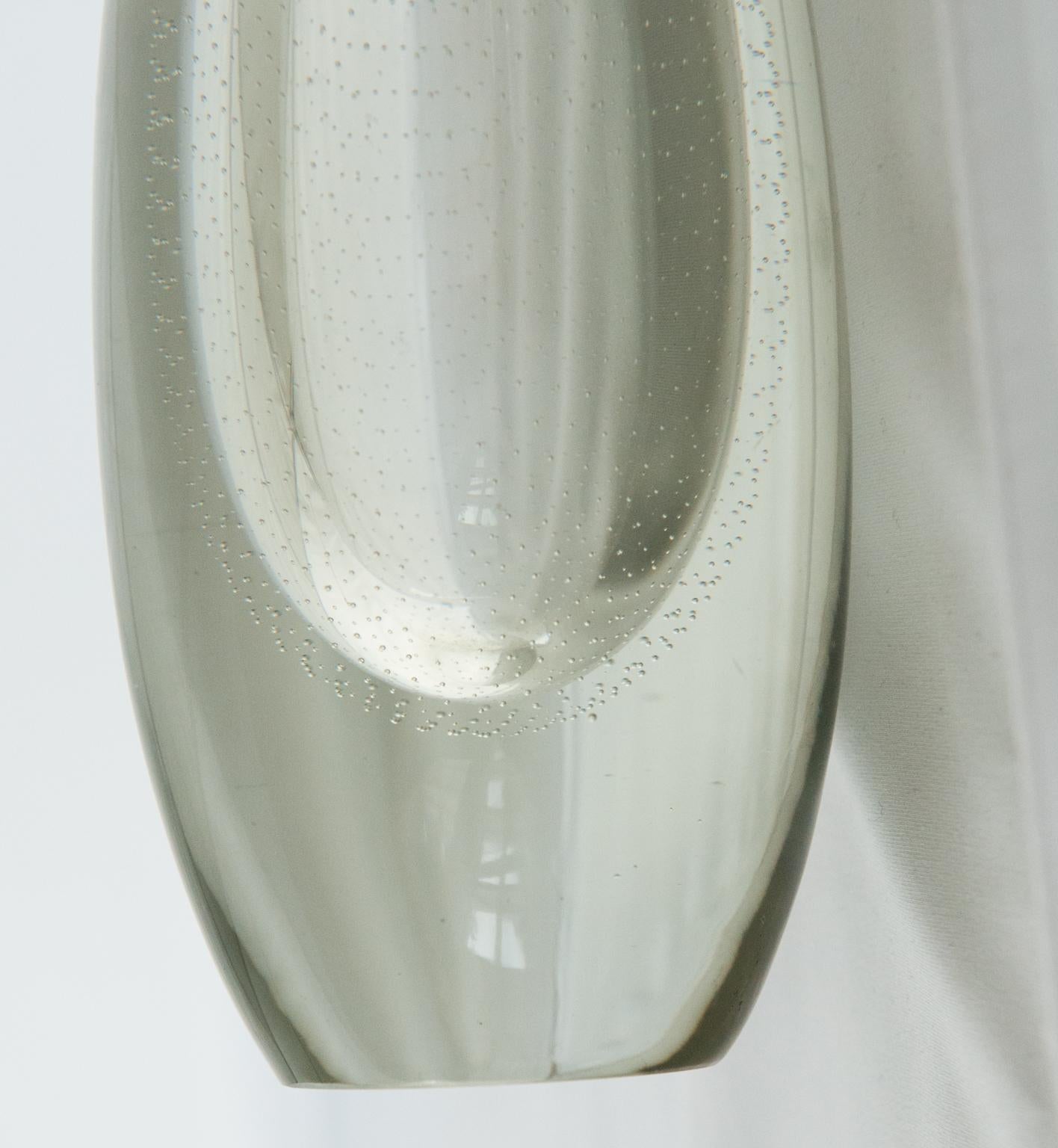 This beautiful hand blown vase in transparent glass is signed G. Nyman, Nuutajärvi, Notsjö.

Gunnel Nyman, 1909-1948, was a Finnish designer. She worked with Notsjö glass factory where she designed modern art glassware.