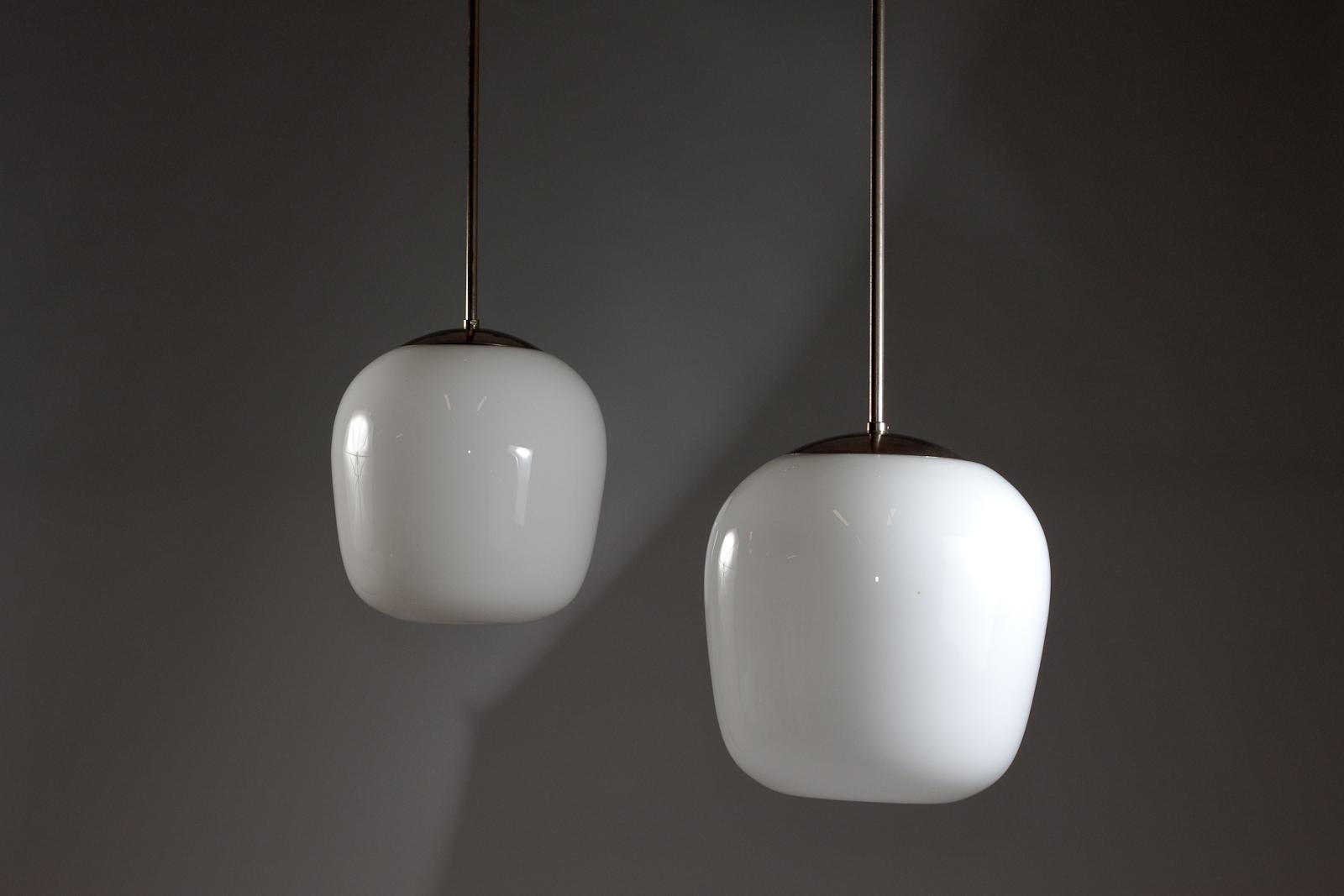 Mid-Century Modern Gunnel Nyman, pair of 1940's opaline glass pendant lamps for Idman Oy For Sale