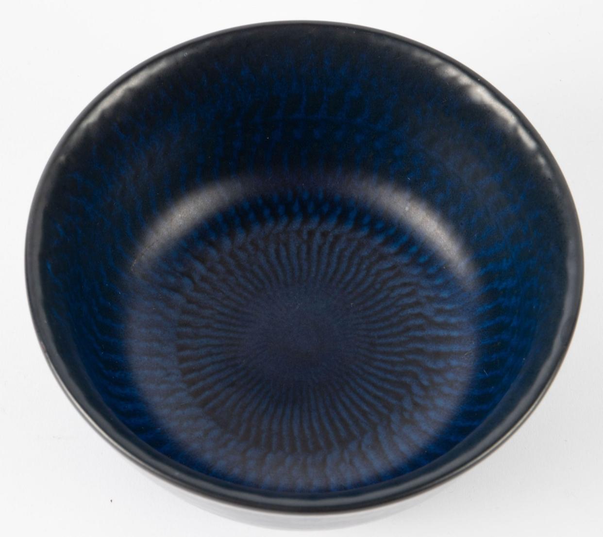 Demure dark blue bowl with black pattern striations by Gunnar Nylund for Nymolle. Perfect shelf piece or put it into use as a console table catch all. Excellent craftsmanship for a piece that doesn’t turn up on these shores often. 