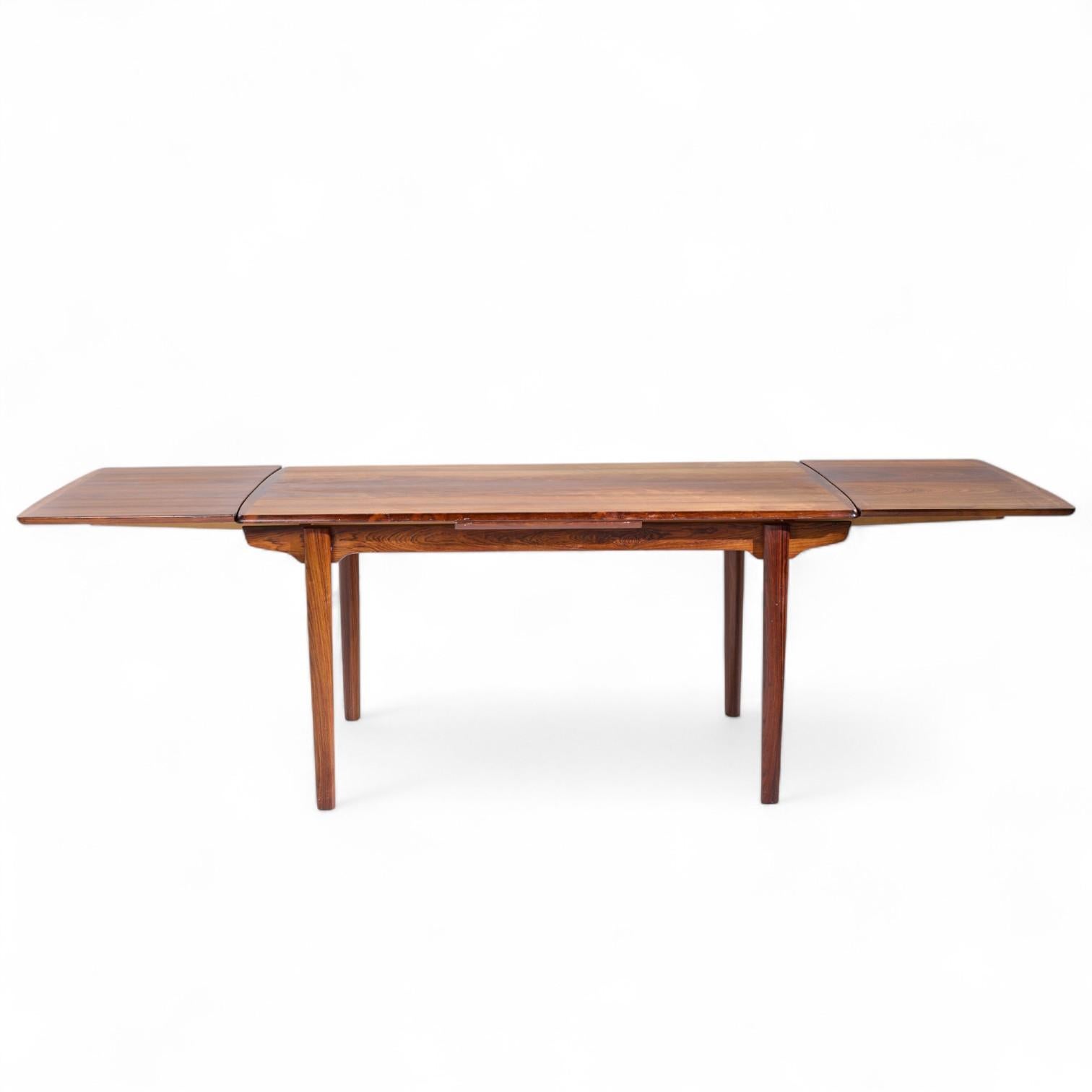 Gunni Omann for Omann Jun Mid Century Danish Rosewood Hidden Leaf Expanding Dining Table

This table measures: 59 wide x 35.25 deep x 28.75 inches high, with a chair clearance of 27 inches, each hidden leaf measures 20.5 inches wide, making a