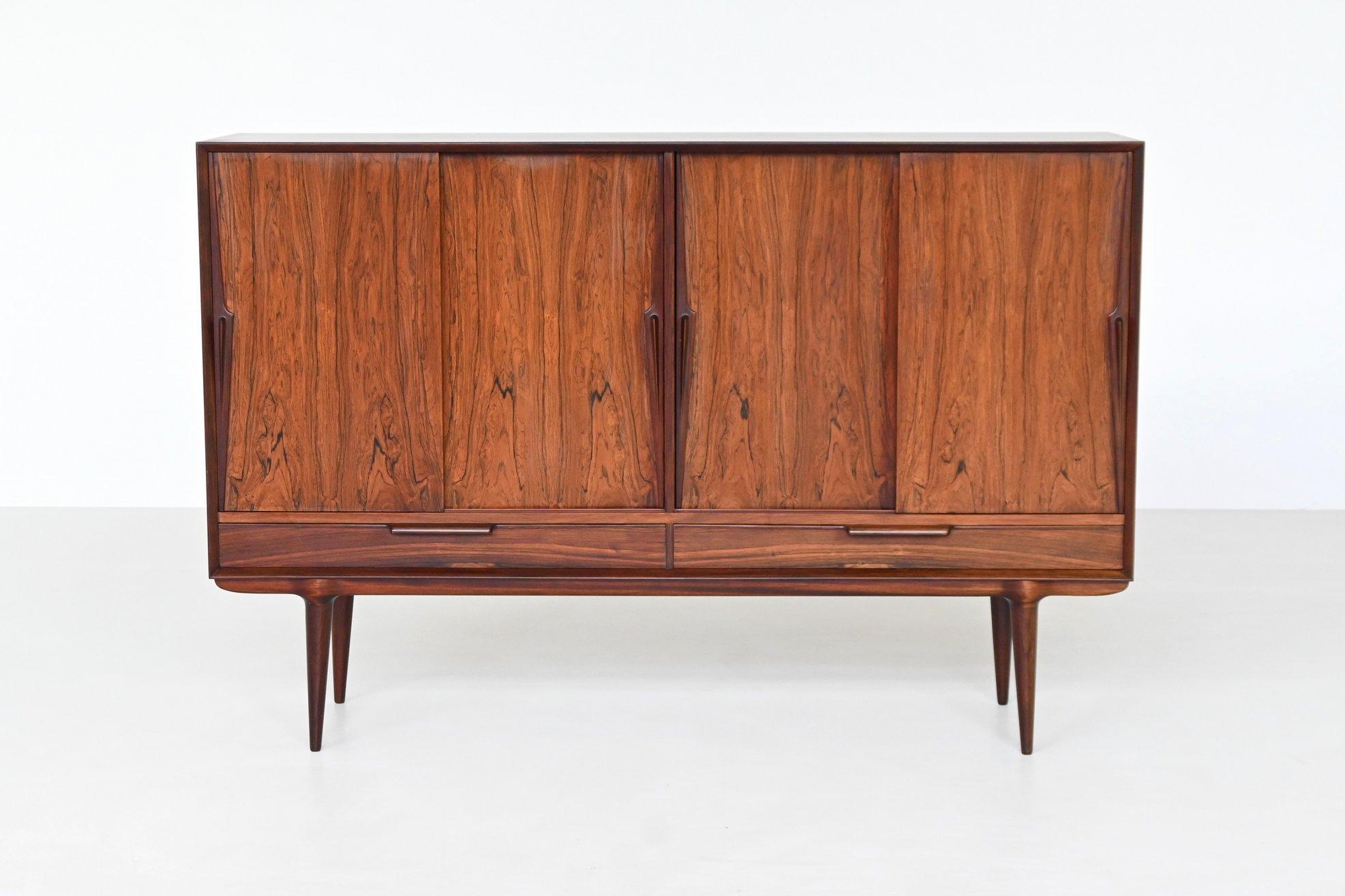 Beautiful highboard model 13 designed by Gunni Omann and manufactured by Omann Jun, Denmark 1960. Superb example of Danish refined furniture. This rosewood highboard features wonderful details and great craftsmanship which Omann Jun and Gunni Omann