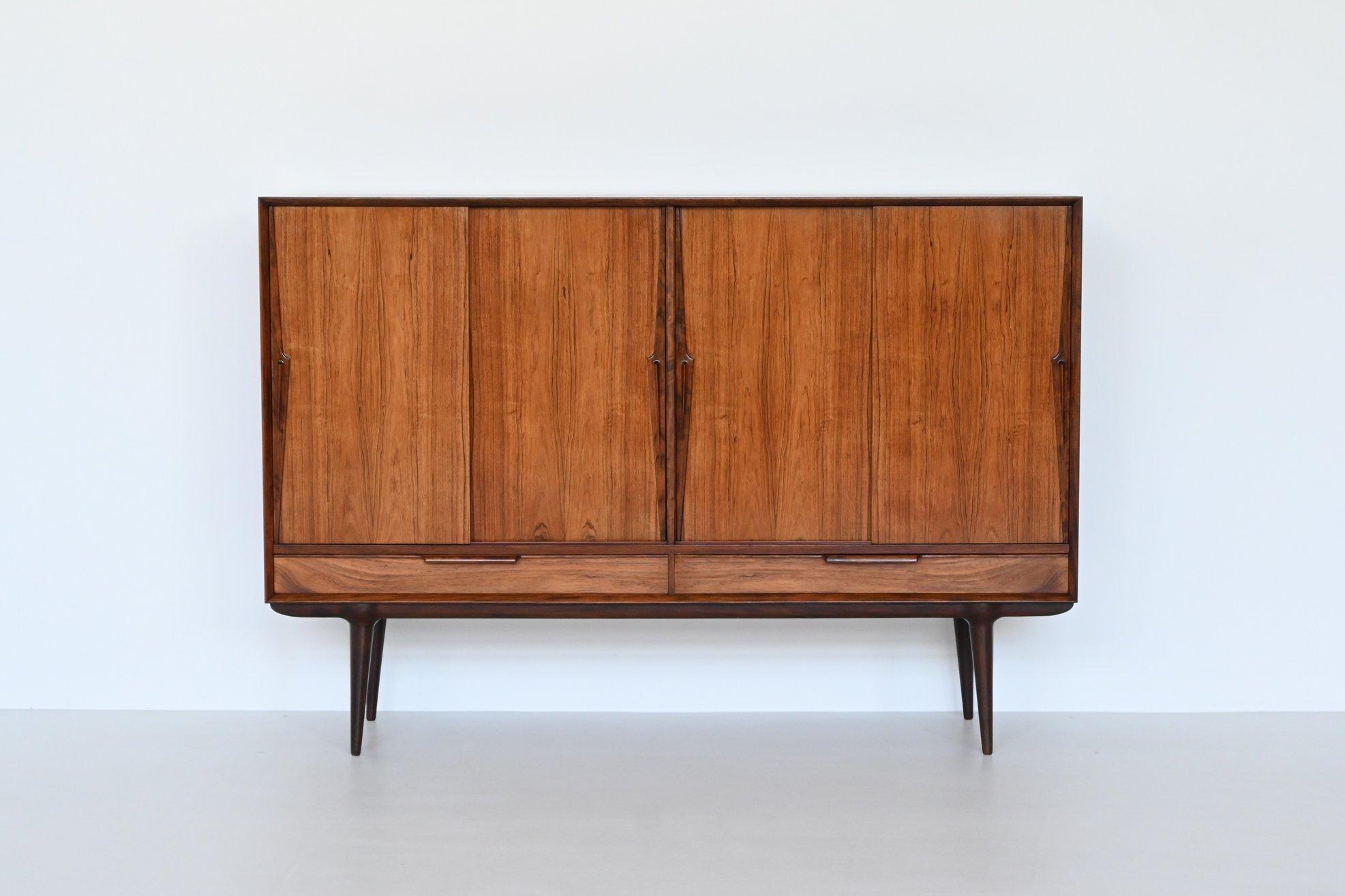 Beautiful highboard model 13 designed by Gunni Omann and manufactured by Omann Jun, Denmark 1960. Superb example of Danish refined furniture. This rosewood highboard features wonderful details and great craftsmanship which Omann Jun and Gunni Omann