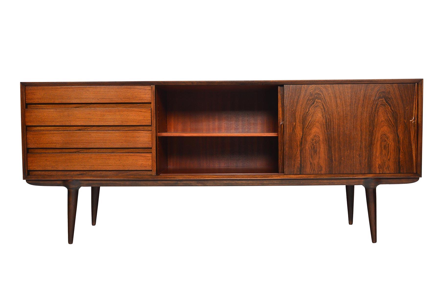 Large Danish modern midcentury rosewood Model #18 credenza designed by Gunni Omann for Omann Jun Møbelfabrik. Perfectly proportioned, with a low profile design, this piece will work well with any modern decor. Doors accented by beautifully hand