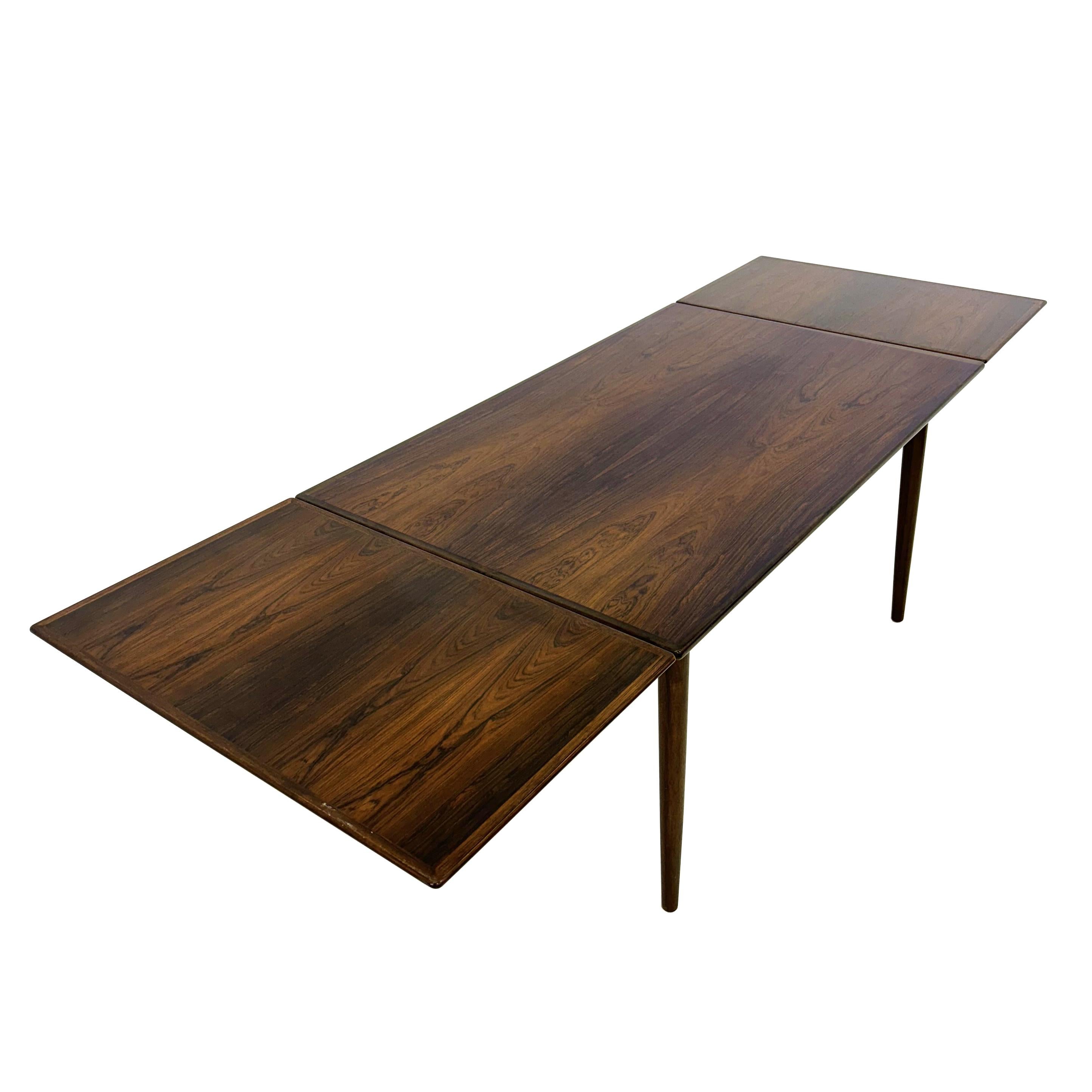 Dining table model 54  designed in 1962 by Gunni Omann and manufactured by Omann Junior Denmark.
This. model  can be extended to a total length of about 245 cm.
Extensions while not in use slide under the table 

Dimensions: 73 cm hight x 145/245 cm