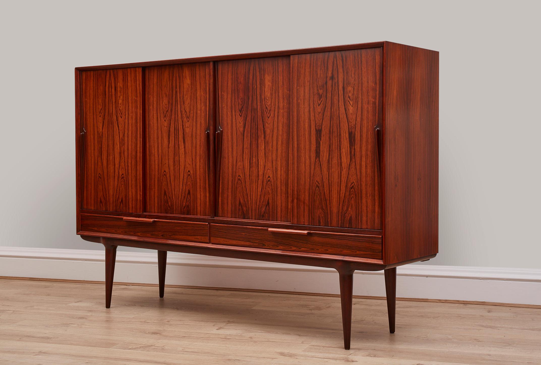 Extremely beautiful Danish sideboard in rosewood, this was designed by Gunni Omann for Axel Christensen. It was made in Denmark from the 1960's
 
In amazing condition for its age and has been re-polished, so looks brand new.

Gunni Omann began his