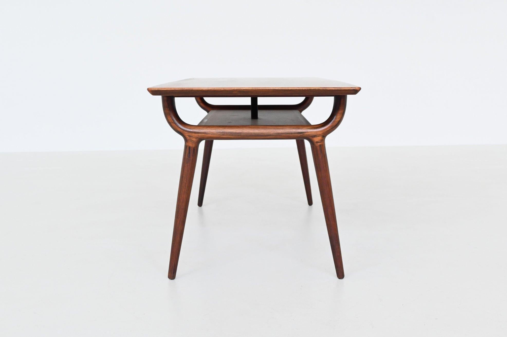 Sculptural coffee table designed by Gunni Omann for Omann Jun Møbelfabrik, Denmark 1958. This coffee table his exemplifies the elegance and craftsmanship of mid-century Danish design. Crafted from gorgeous grained rosewood, the table showcases a