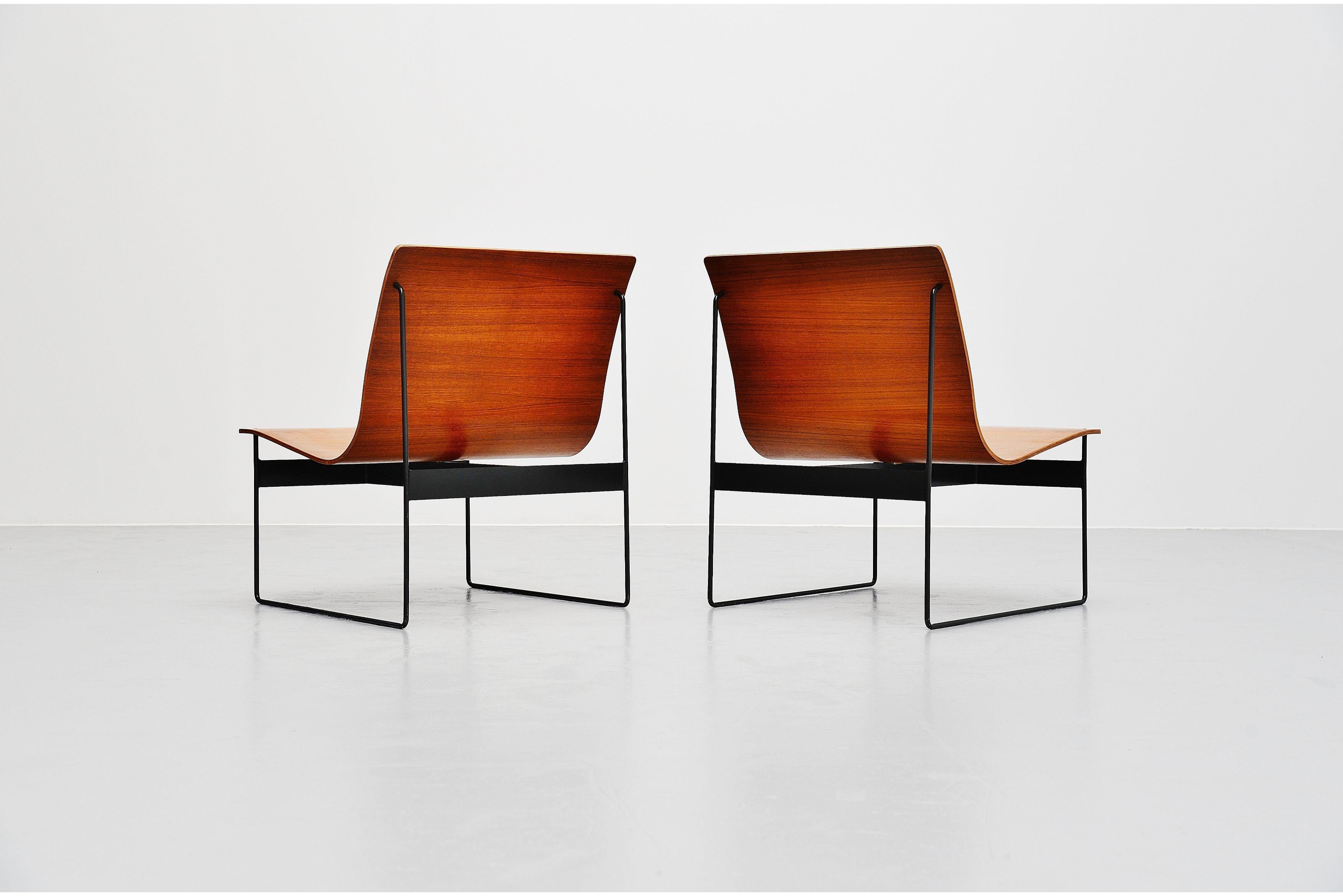 Stunning pair of teak plywood lounge chairs designed by Günter Renkel and manufactured by Rego, Germany, 1959. These chairs are made of teak plywood and have solid metal sophisticated sledge frames, very dark grey lacquered. The chairs have a very