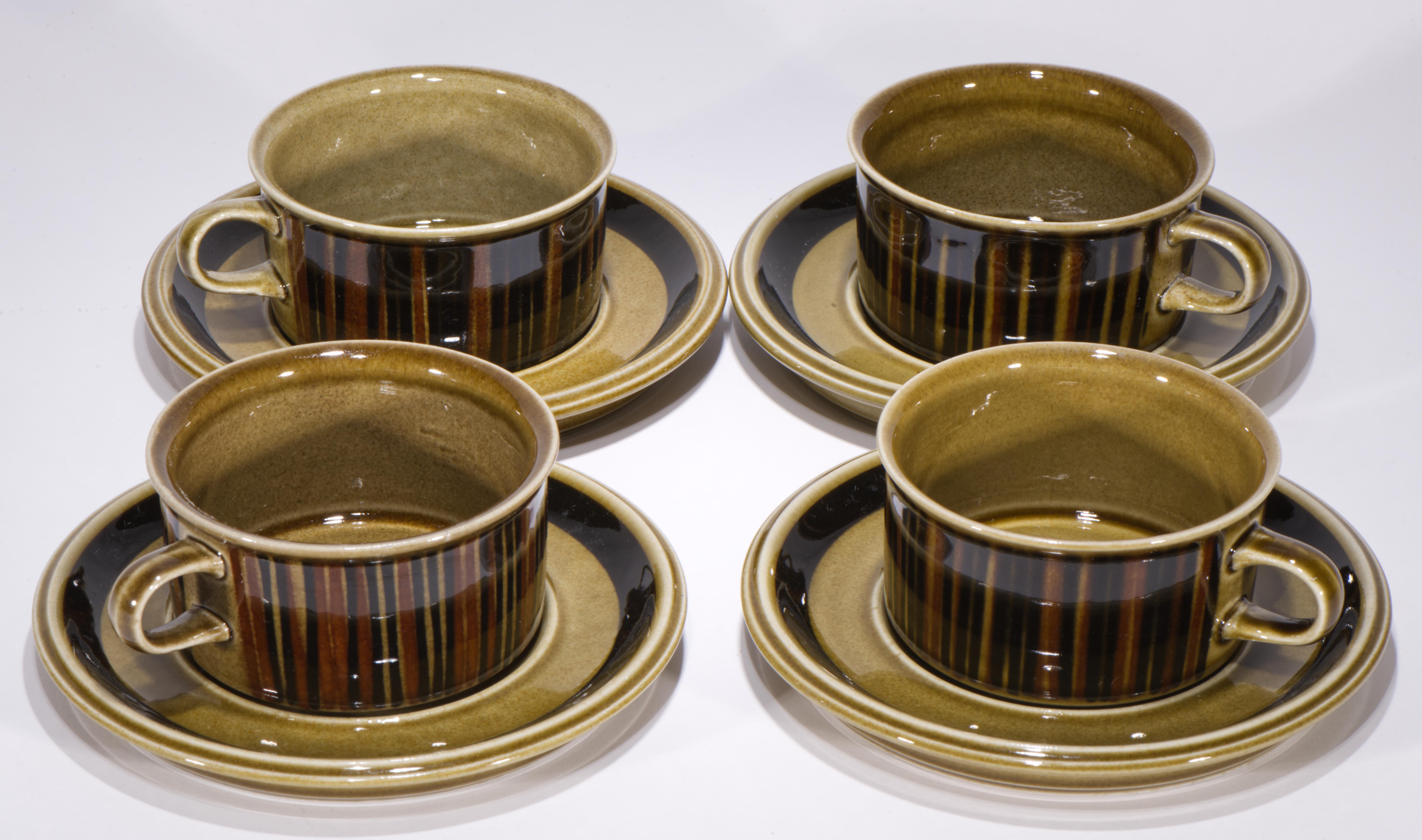  Vintage set of 4 tea cups and 4 saucers (2 sets available) features “S” model forms designed by Ulla Procopé and Kosmos decor in brown colorway, designed by Gunvor Olin-Grönqvist. Kosmos was in production from 1962 to 1976. The parallel vertical