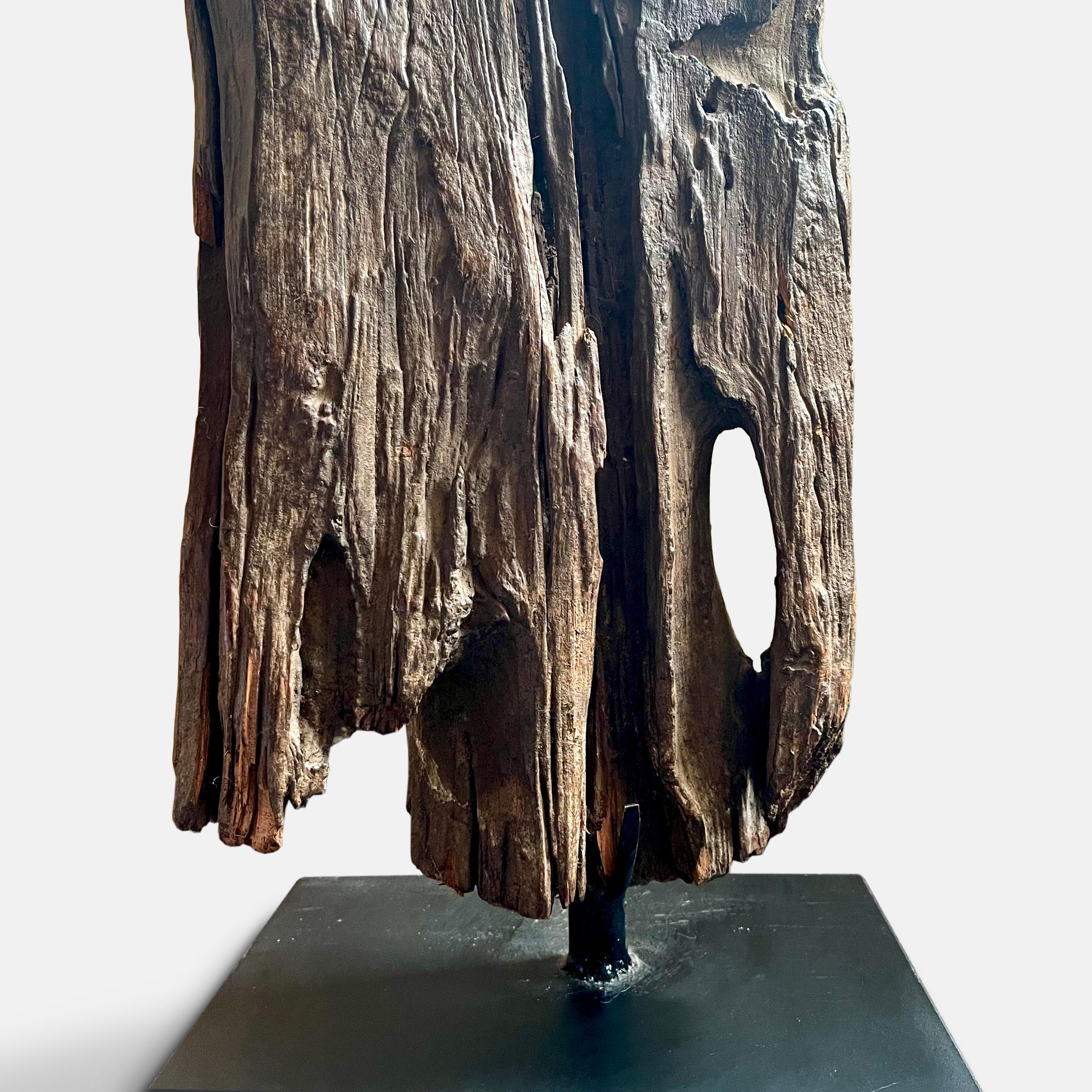 With a beautiful dark patina of regular use, and dating from the late 19th or early 20th century, this thick board with its deeply inscribed vertical lines, is of the type used by the Gurage people of Ethiopia. Planted upright in the ground, as seen
