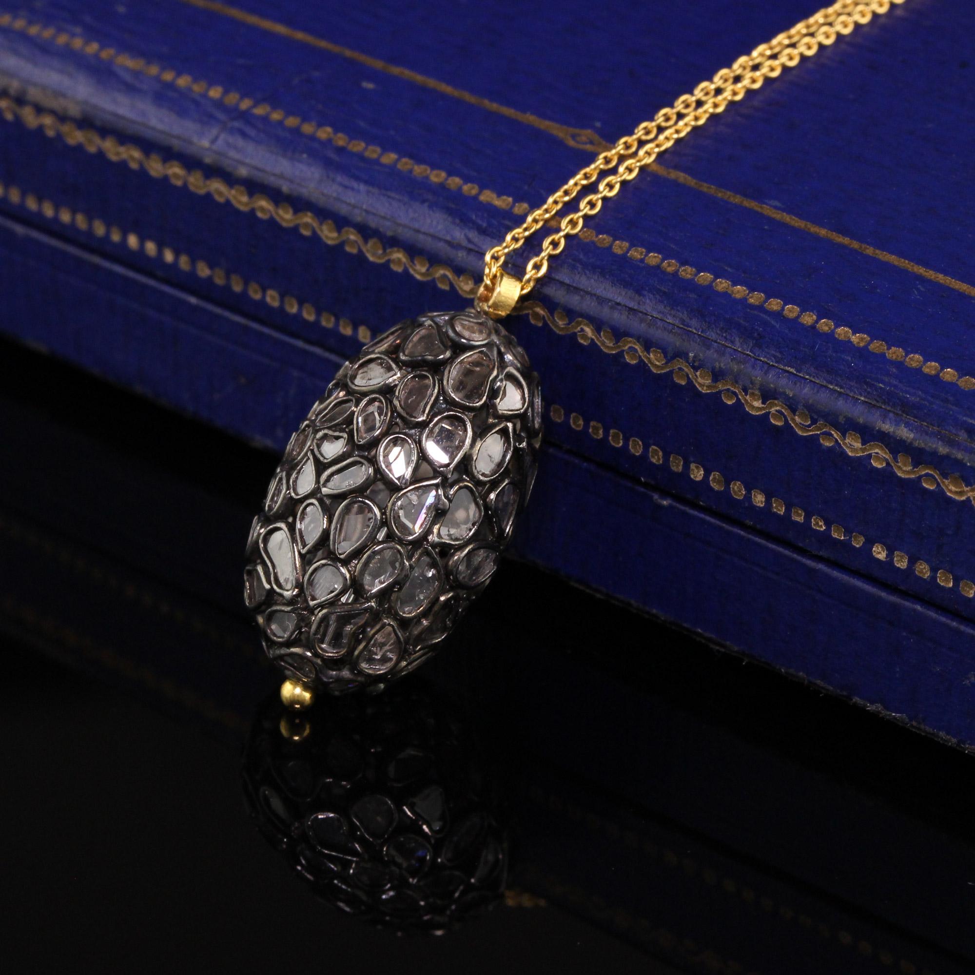 Gorgeous Gurhan 18K Yellow Gold and Silver Rose Cut Diamond Oval Globe Pendant. This pendant has rose cut slices going around the entire pendant. The pendant also spins and comes with its original 18 inch chain.

Item #N0057

Metal: 18K Yellow Gold
