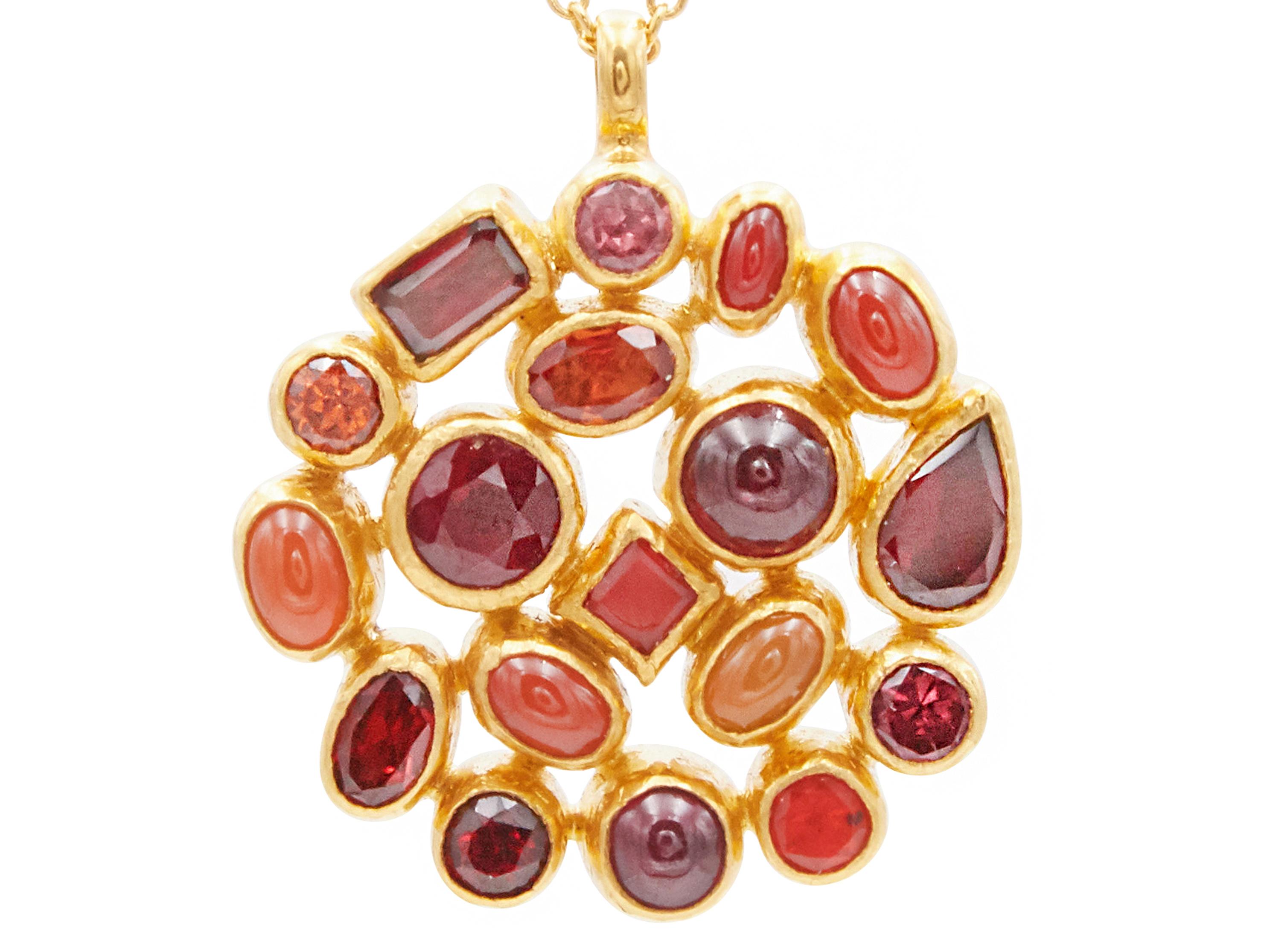 GURHAN one-of-a-kind pendant necklace set in 24 Karat hammered yellow gold featuring (18) mixed sized and shaped cabochon and faceted stones; (3) Rubies 4.93cts., (4) Red Garnets 2.49cts., (2) Rhodolite Garnets 0.62cts., (1) Fancy Sapphire 0.52cts.,