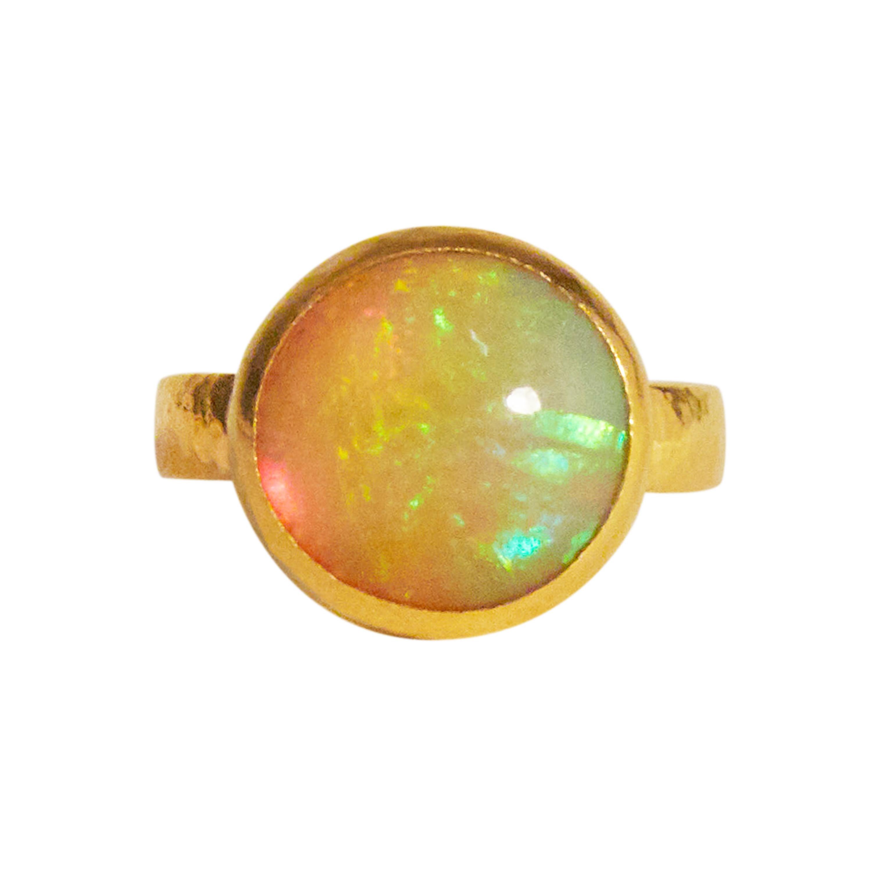 GURHAN one-of-a-kind ring set in 24 Karat hammered yellow gold featuring a 13mm round cabochon Ethiopian Opal, 7.02cts. Bezel stone setting, 22 Karat hammered yellow gold shank, size 6.5.