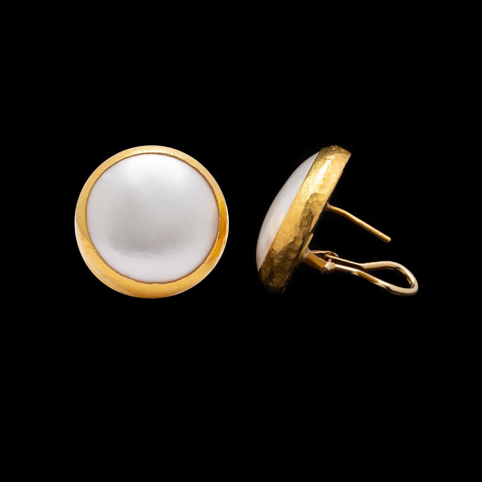 Bold and contemporary, these Gurhan 22k gold earrings will be a staple in ones collection.  Featuring coin shaped cultured pearls, bezel-set in hammered gold, with omega clip backs, they are a simple and strong design, great for dress up or everyday