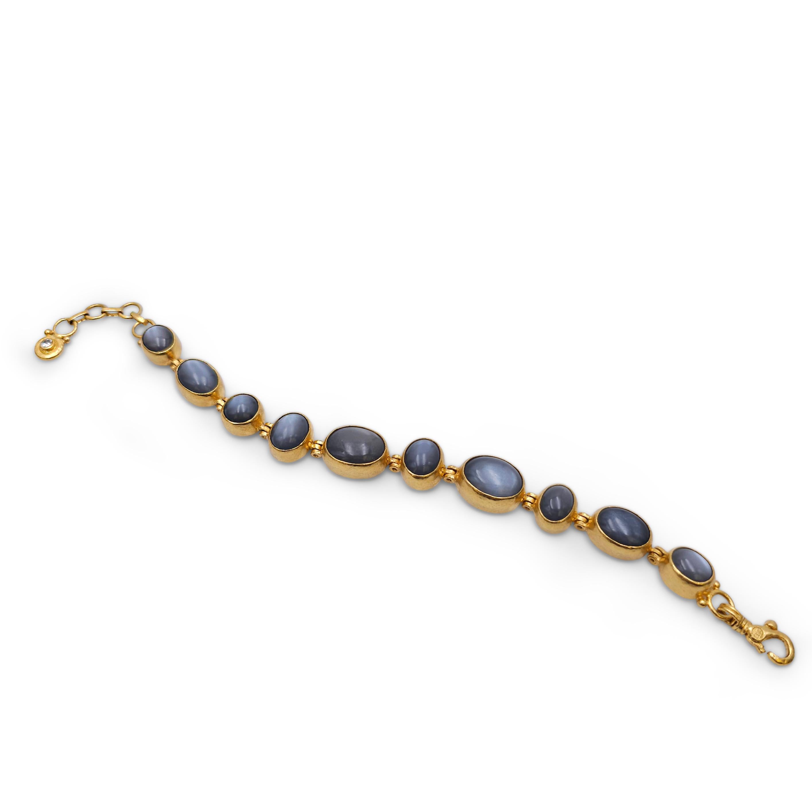 Authentic Gurhan bracelet crafted in 24 karat yellow gold.  Featuring bezel set cabochon black moonstones of varying sizes and bezel set diamonds at each end for an estimated 0.10 carats total diamond weight.   The bracelet measures 8 1/4 inches in