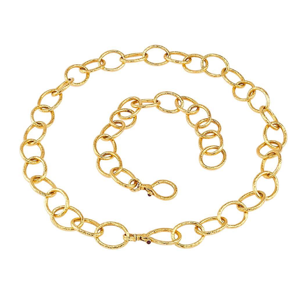 Gurhan gold link necklace and matching bracelet. The handcrafted, 24-karat gold, matching designs composed by large oval links embellished by a light hammered texture, completed by integrated clasps, each featuring a bezel-set cabochon ruby. Can be