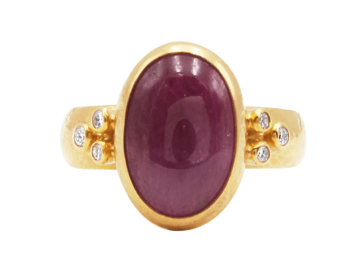 GURHAN one-of-a-kind cocktail ring set in 24 Karat hammered yellow gold featuring a 15x11mm oval cabochon Ruby, 7.70 cts., and (6) brilliant white diamonds, 0.118 cts. Bezel, vertical stone setting with graduated shank, size 6.5.

