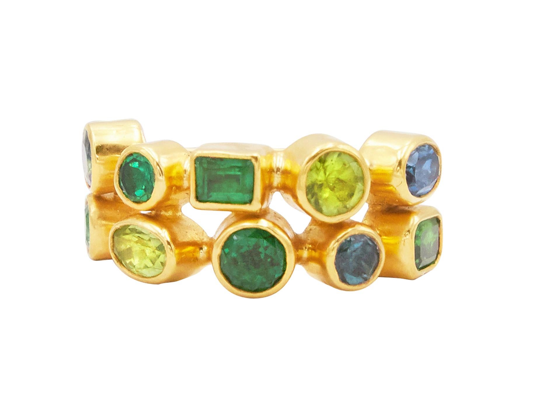 GURHAN one-of-a-kind cocktail ring set in 24 Karat hammered yellow gold featuring (10) mixed sized and shaped stones; (1) Sapphire, (1) Blue Topaz, (1) Tourmaline, (2) Peridots, (5) Tsavorites, 4.35 total carat weight.  Bezel setting with 22 Karat