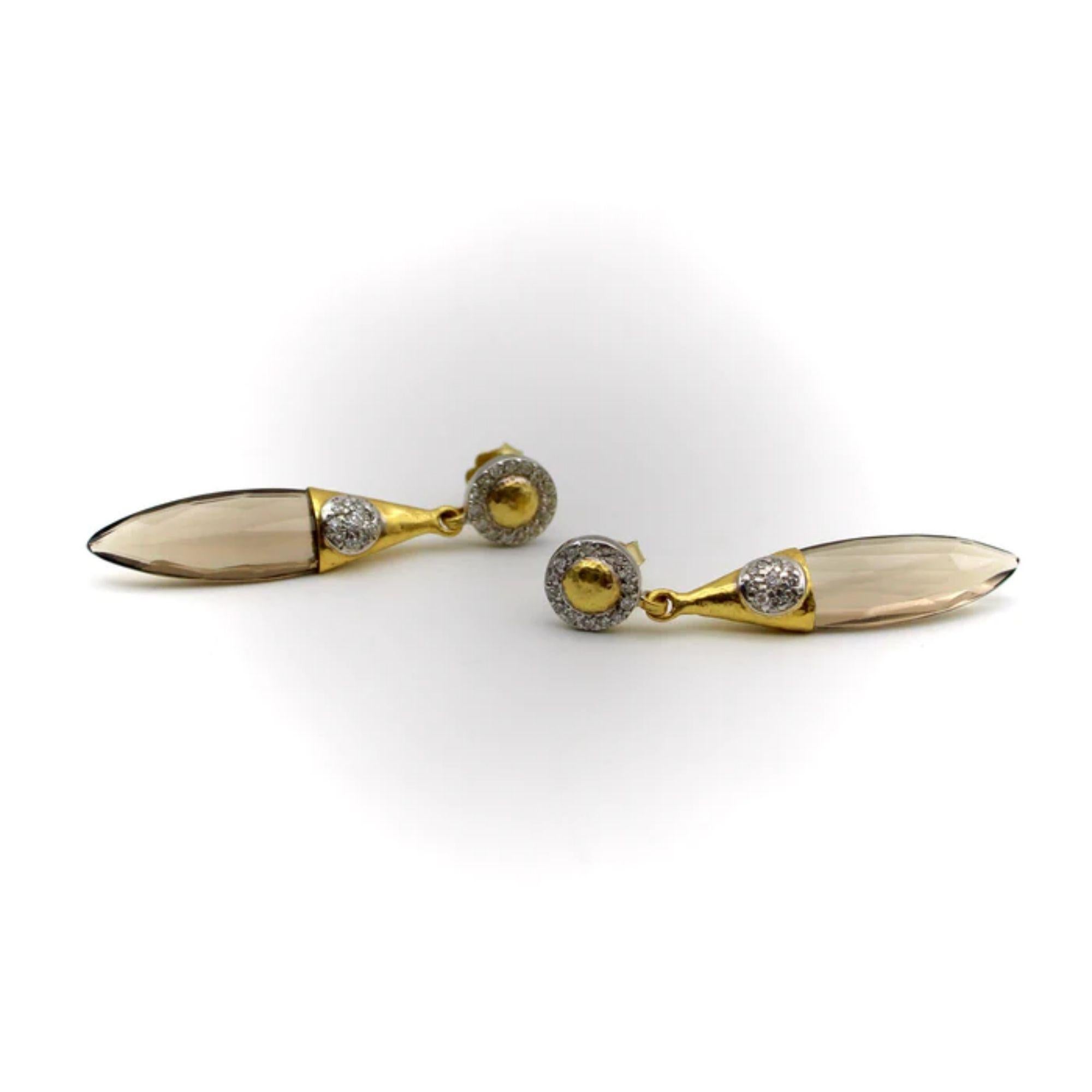 Gurhan 24K and 18K Gold Smoky Quartz Drop Earrings, 1990
 
These Gurhan earrings feature an elongated briolette cut smoky quartz drop, wrapped with hand hammered 24k gold. Th earring’s dangle is decorated with a diamond flower, bead set into 24k