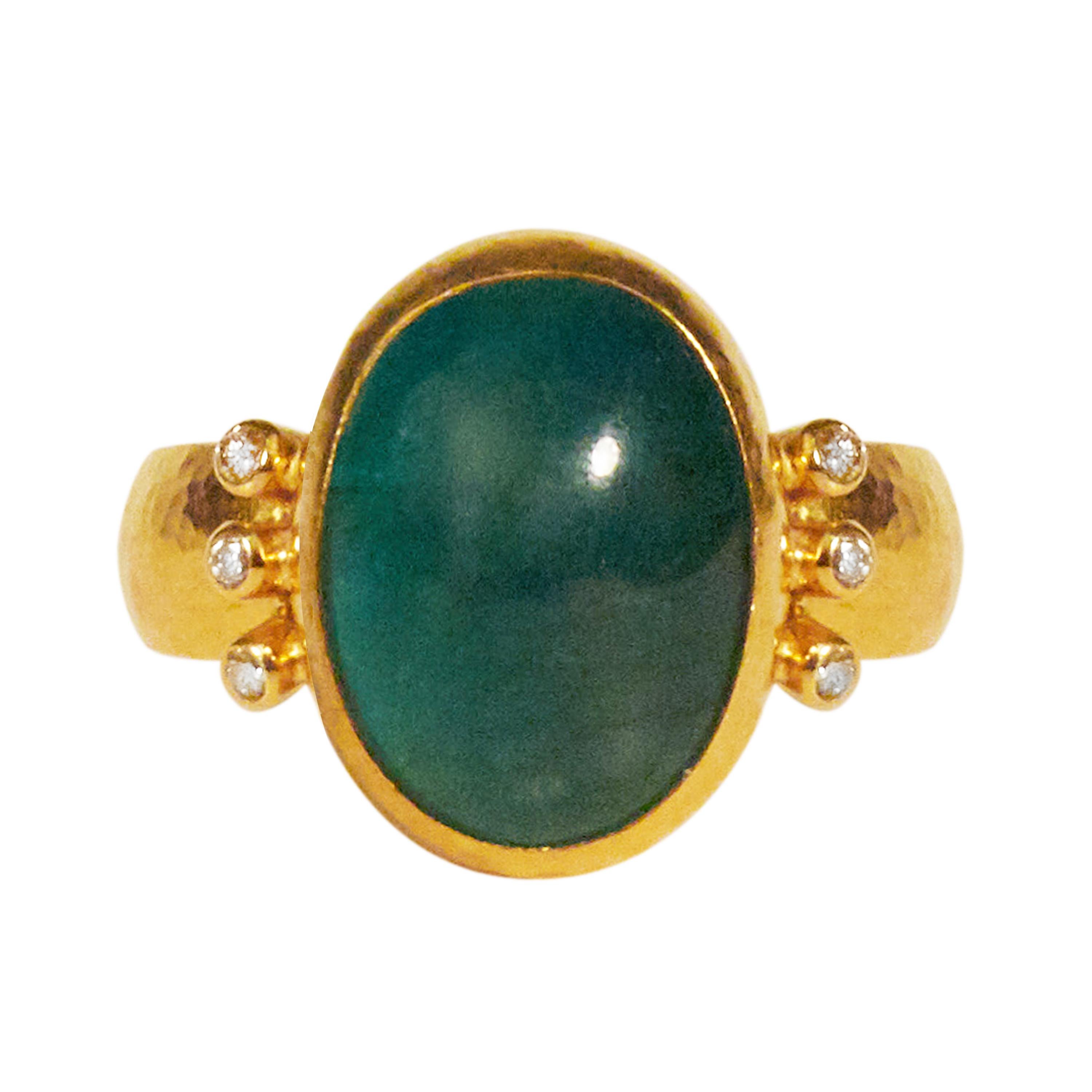 GURHAN one-of-a-kind ring set in 24 Karat hammered yellow gold featuring a 15x12mm oval cabochon Emerald, 9.86cts, with (6) brilliant white diamonds, 0.096cts. Bezel, vertical stone setting, size 6.5.