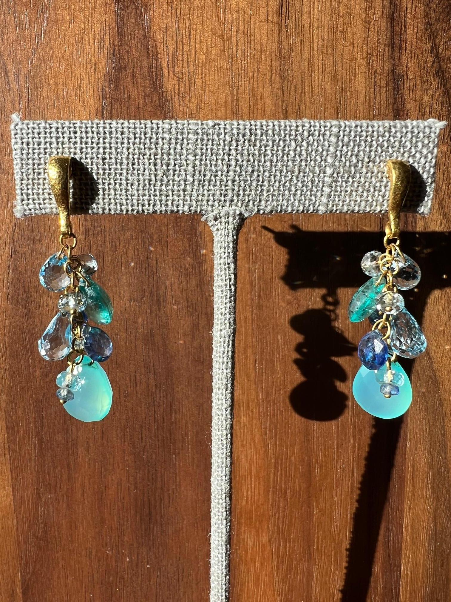 Elevate your jewelry collection with these stunning Gurhan dangle earrings. Crafted from 24-karat yellow gold, these earrings feature a beautiful combination of blue sapphire and aquamarine gemstones. The blue hue of the gemstones perfectly