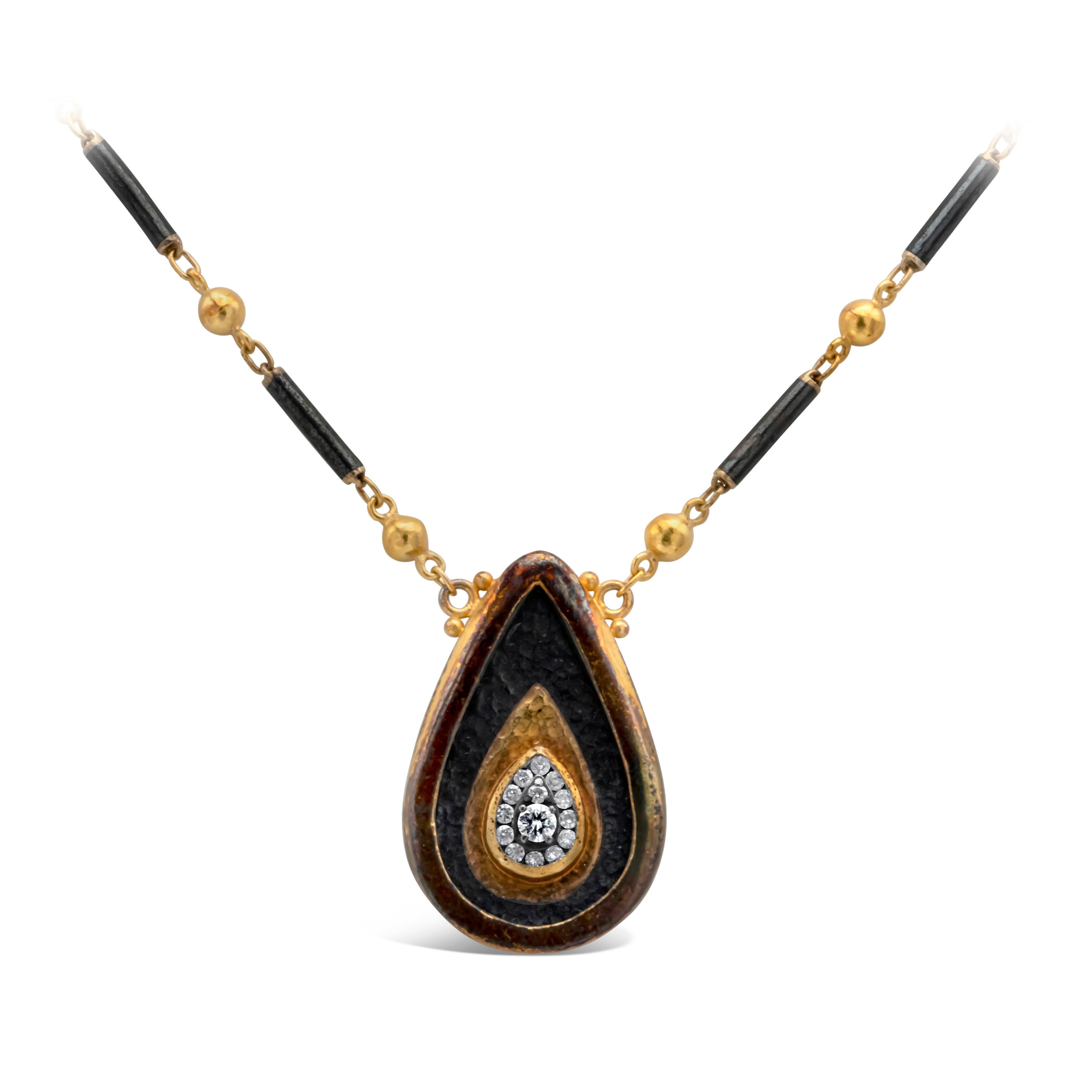 Pendant necklace showcasing a large pear shape tear drop design made with yellow gold and blackened silver top, crafted with 14 round diamonds weighing 0.25 carats total. Suspended on a GURHAN jet set yellow gold single strand with jet beads chain.