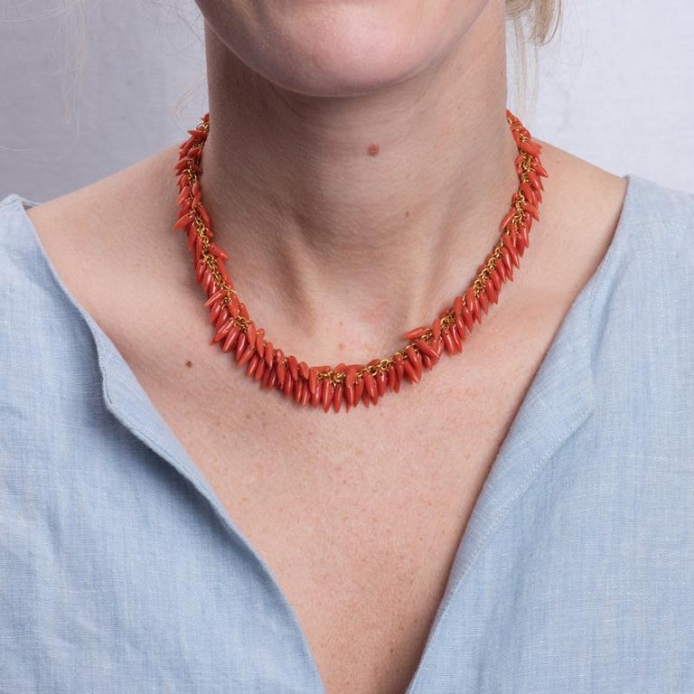 This beautiful necklace from Gurhan features natural coral that drapes from an 18 karat yellow gold adjustable chain. The total length is 16.5