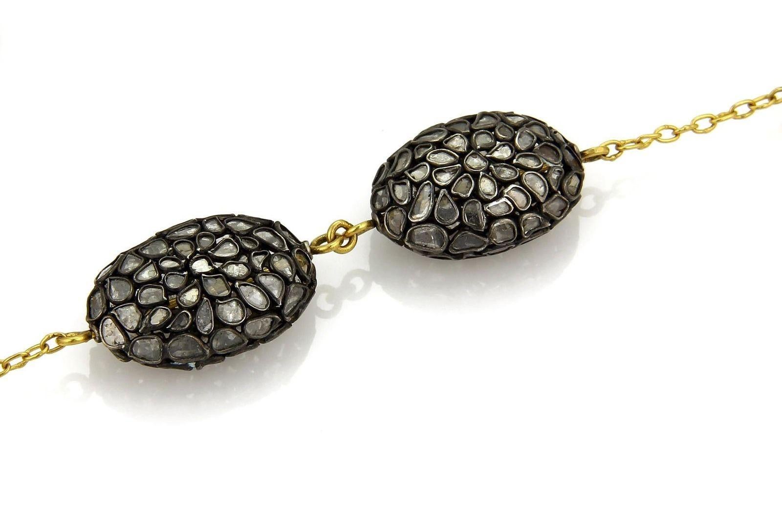 This is an impressive authentic necklace by Gurhan from the PASTICHE collection. It is crafted from 24k gold and sterling silver in black rhodium. It features 3 hand hammered oval beads in yellow gold with 6 pastiche pods in darkened silver with