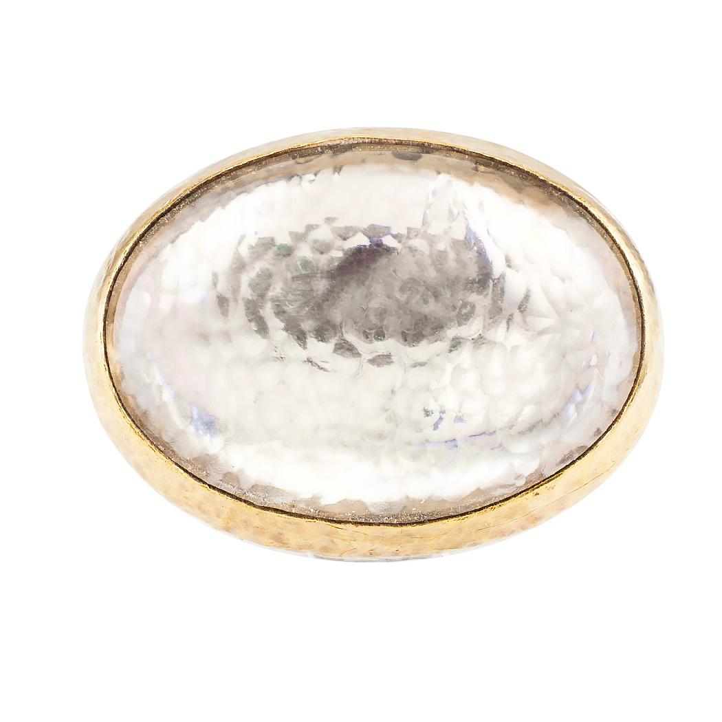 Gurhan rock crystal sterling silver and gold cocktail ring.

DETAILS:

GEMSTONES:  one clear color cabochon rock crystal.

METAL:  sterling silver and 18-karat yellow gold.

WEIGHT:  22.1 grams.

HALLMARKS:  signed Gurhan.

RING SIZE:  approximately