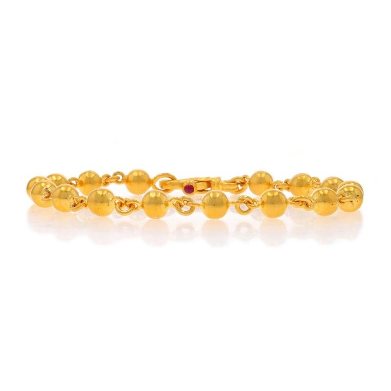 Retail Price: $4750

Brand: Gurhan

Metal Content: 24k Yellow Gold

Stone Information
Natural Ruby
Cut: Round Cabochon
Color: Pinkish Red

Chain Style: Bead Link
Bracelet Style: Chain
Fastening Type: Lobster Claw Clasp

Measurements
Length: 7