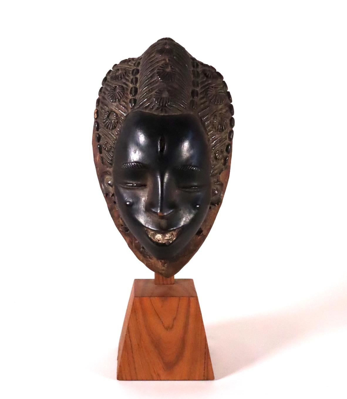 A beatific face mask from the Guro people of the Cote d'Ivoire (Ivory Coast). Wood with paint and white pigment at the mouth. Possibly created by a known 20th century carver, but no provenance can be traced.
One of the main ancestral female