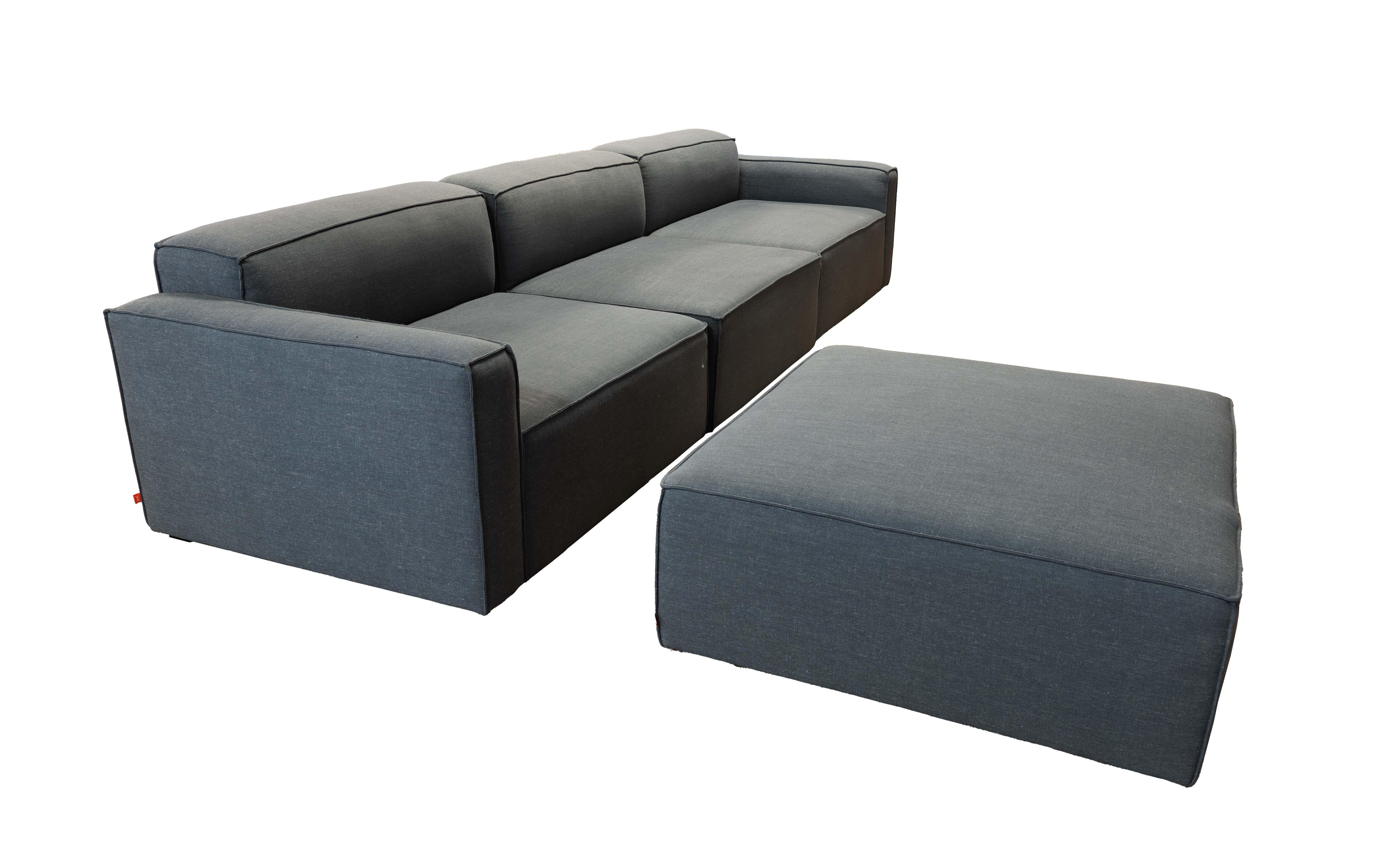 This Gus Mowat Raven Grey 4-Piece Modular Sectional with Chaise is perfect for contemporary living spaces. Upholstered in a sleek and durable grey fabric, it combines clean lines with exceptional comfort. The modular design allows you to customize