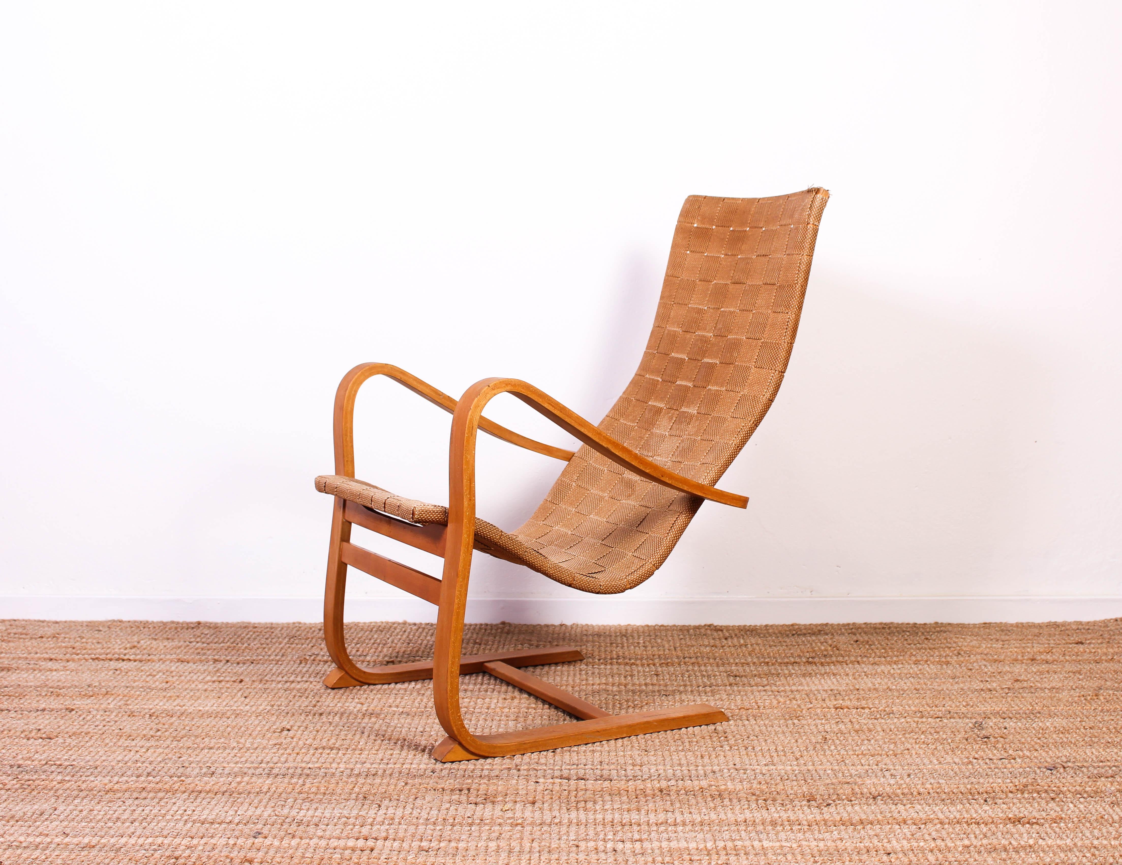 Midcentury lounge chair by Swedish designer Gustaf Axel Berg. The chair was designed and produced in the 1940s and still has its original upholstery.

The chair has heavy signs of usage and patina on frame and canvas. There are no structural