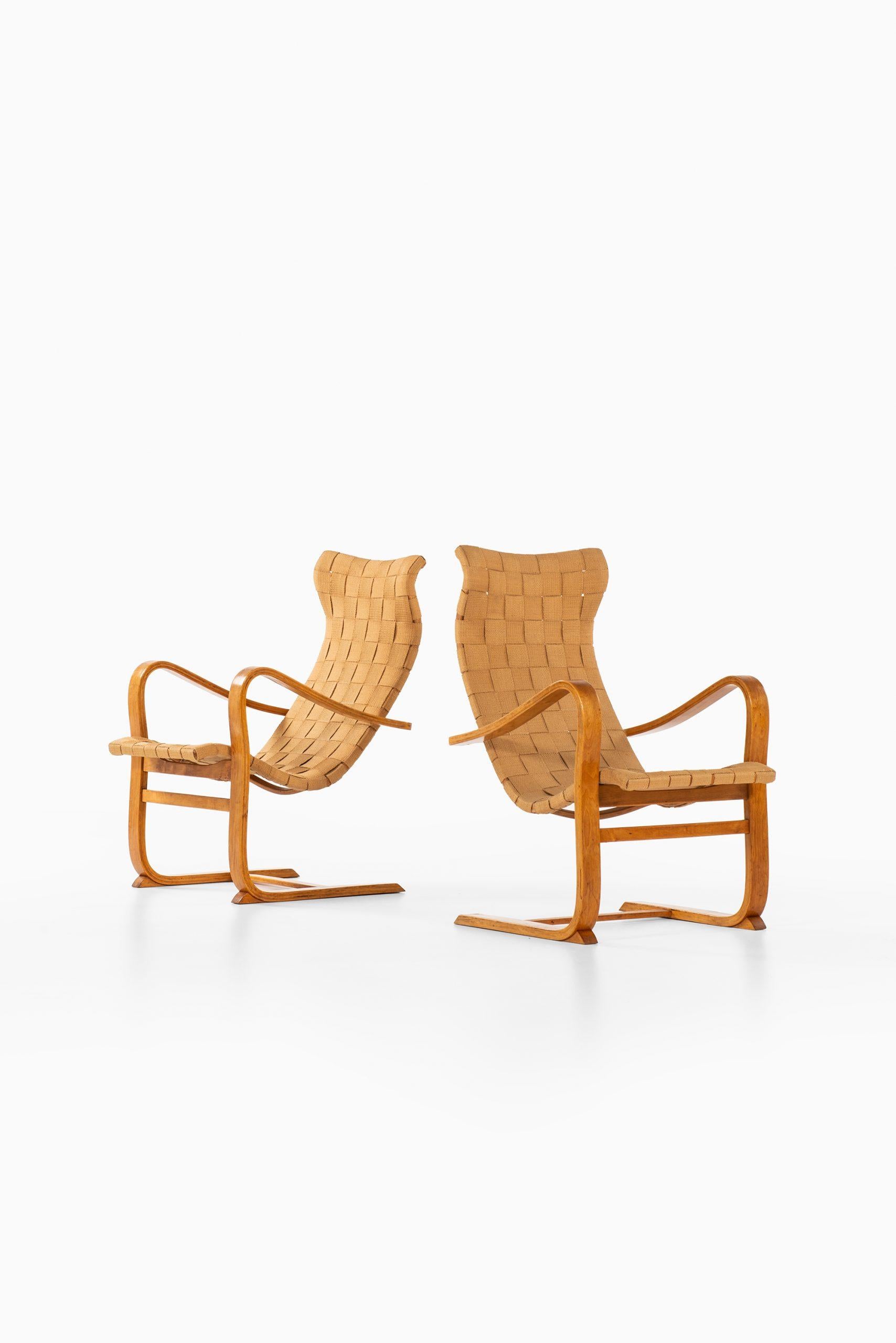 Rare pair of easy chairs model Patronen designed by Gustav Axel Berg. Produced in Sweden.