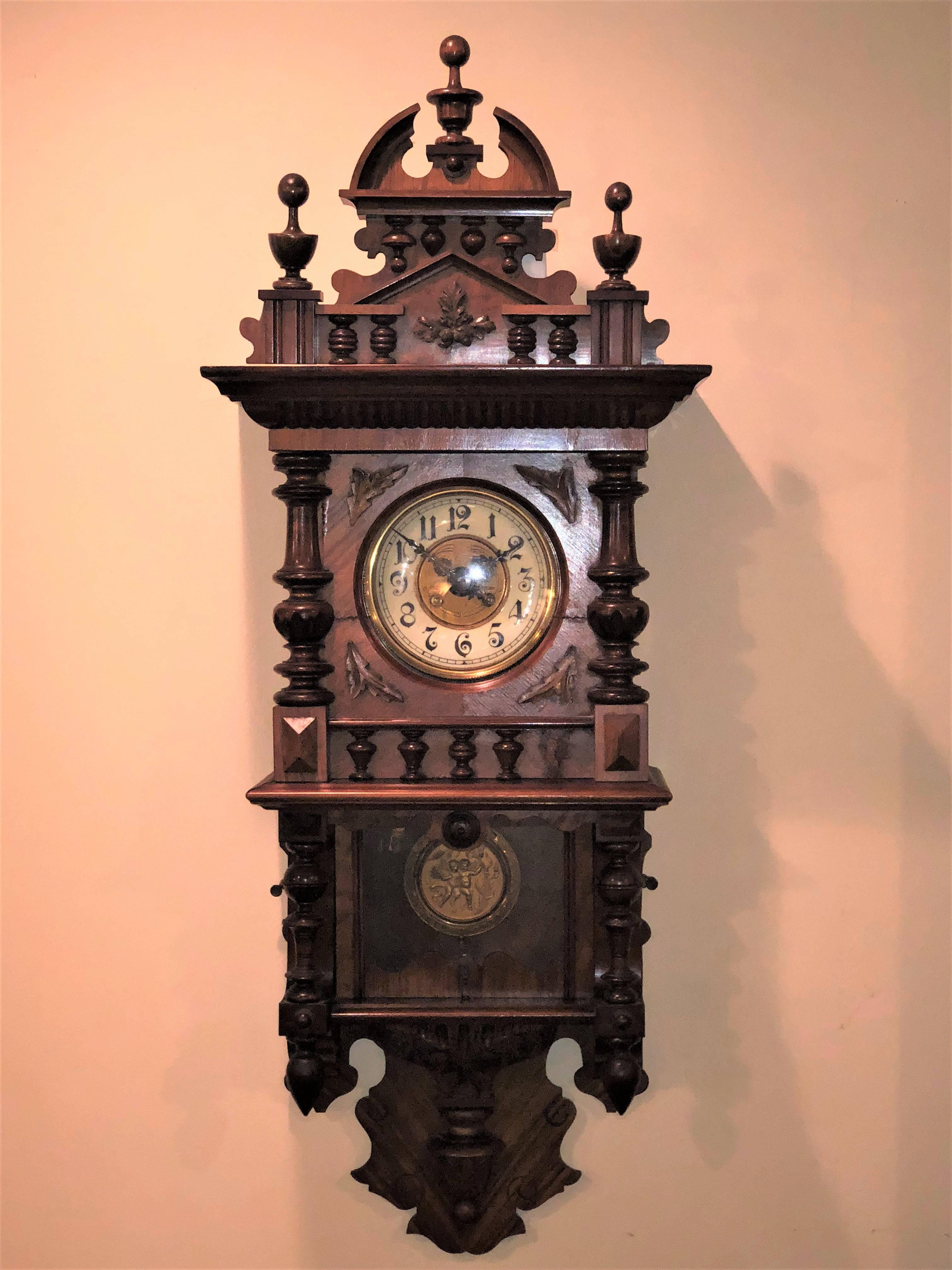 Fine 19th-early 20th century Gustav Becker style Victorian wall clock with key and pendulum. This finely carved and intricately worked case depicts the Victorian golden age at its highest level. The works signed and numbered by Adler. The interior