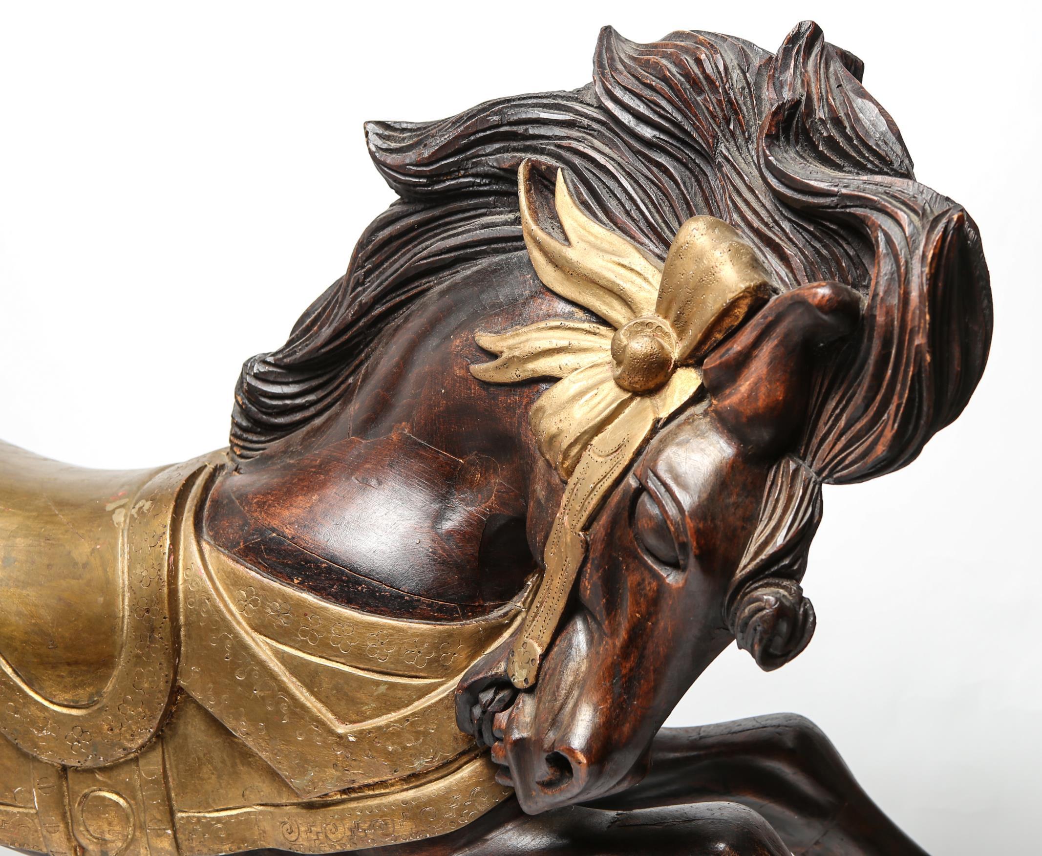 Gustav Dentzel-manner carved and partially gilded wood small galloping carousel horse sculpture with mane. The piece is in great vintage condition.