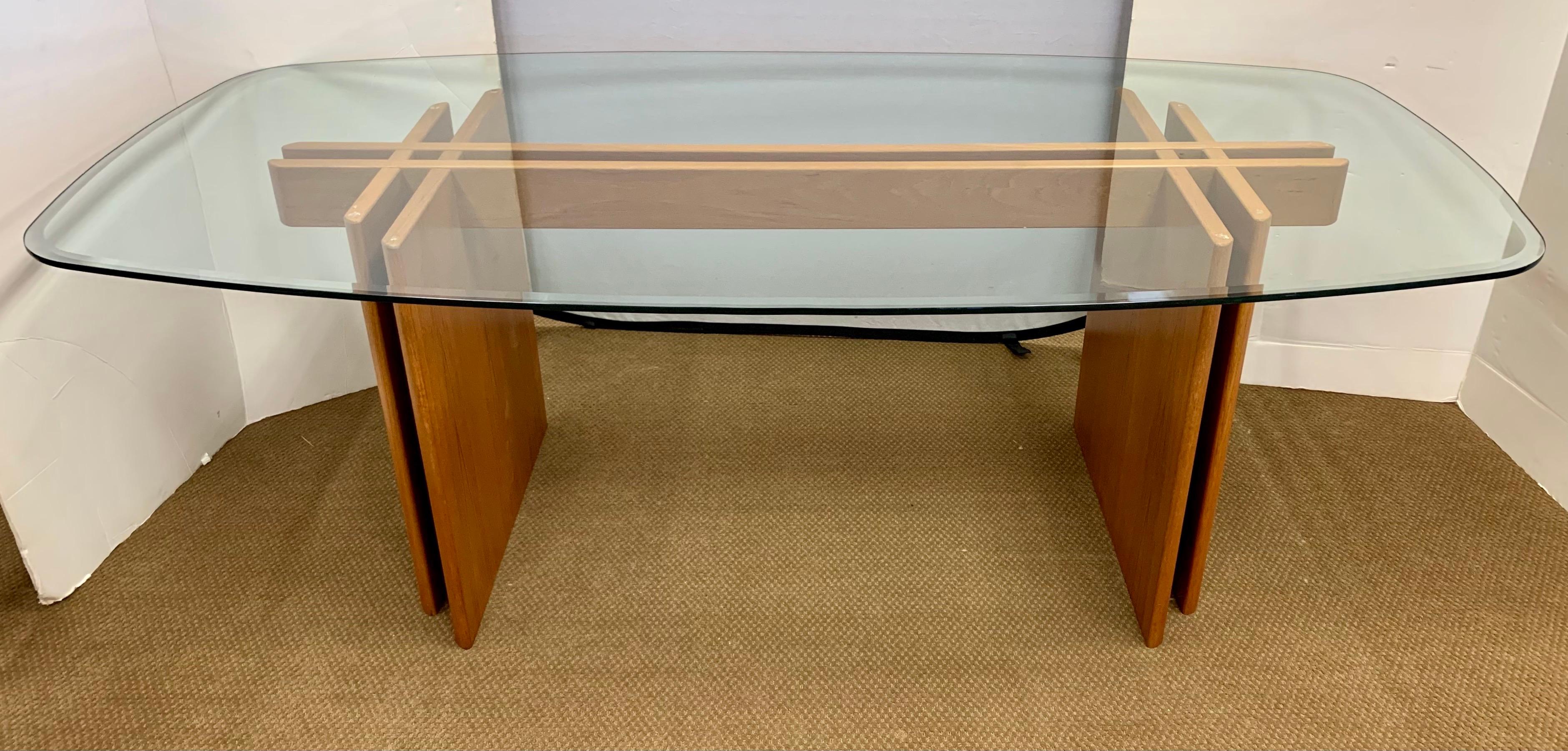 Vintage Danish Modern interlocking teak sculptural dining table with beveled oval/rectangular glass top by Gustav Gaarde for Trakanten.