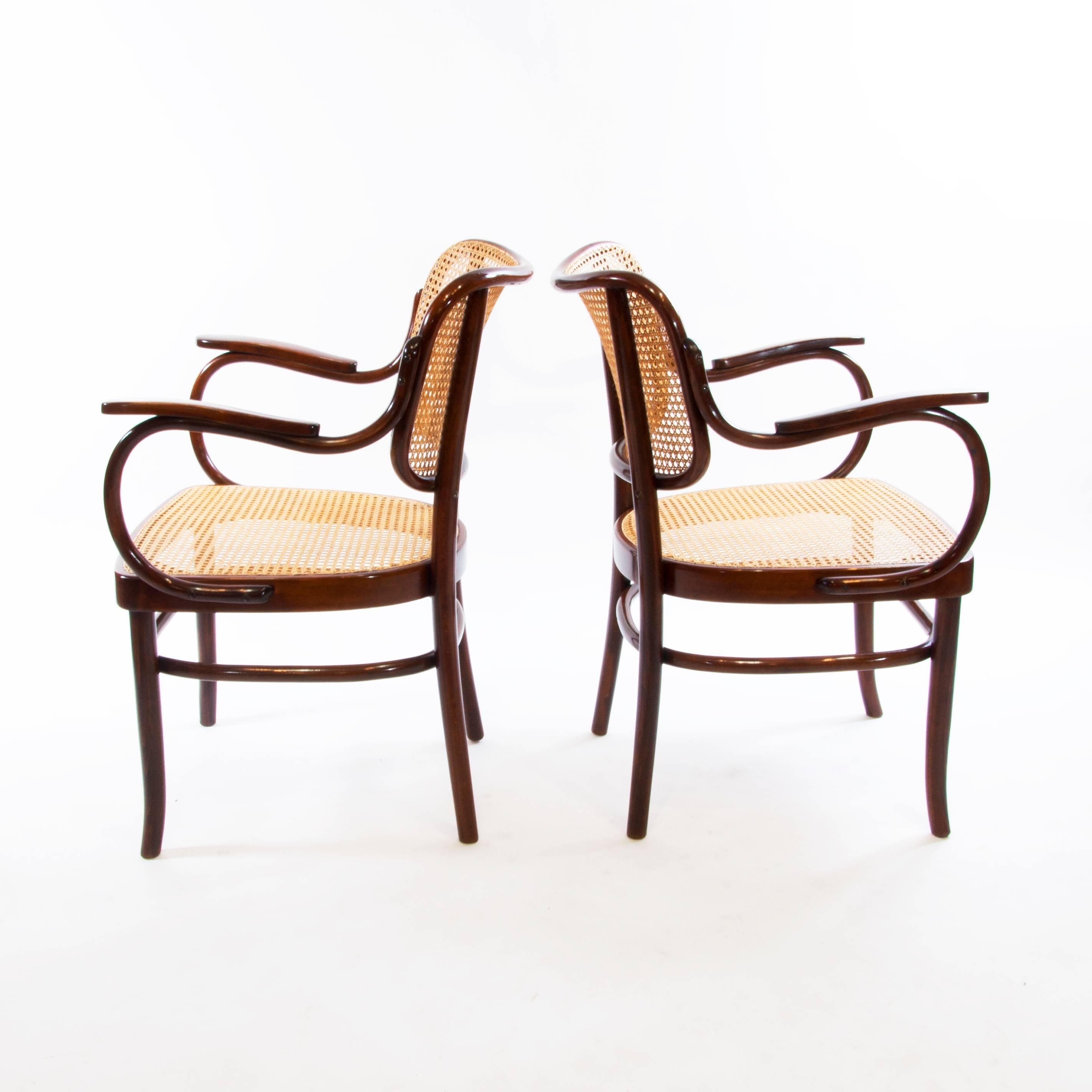 A wonderful pair of design masterpieces. 
Elegance of the organic bentwood curves, warmth of the wickerwork seat and backrest and obpulent style of the 1930s make these armchairs very iconic!
Gustav Schneck was Thonet's creative director and had