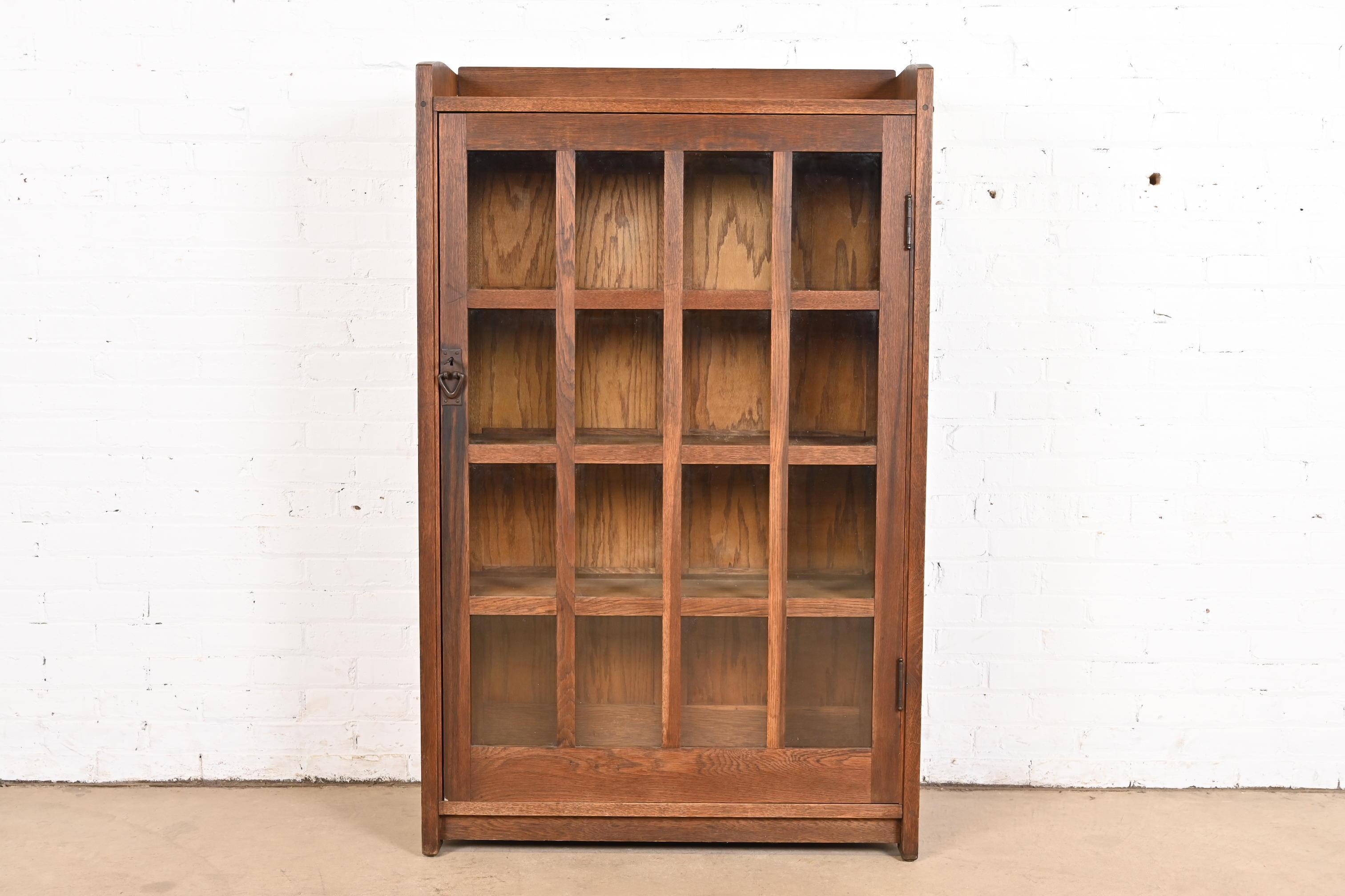 A beautiful antique Mission or Arts & Crafts bookcase cabinet

By Gustav Stickley

USA, Circa 1900

Solid oak, with mullioned glass front doors, and original hammered copper hardware. Cabinet locks, and key is included.

Measures: 35.13
