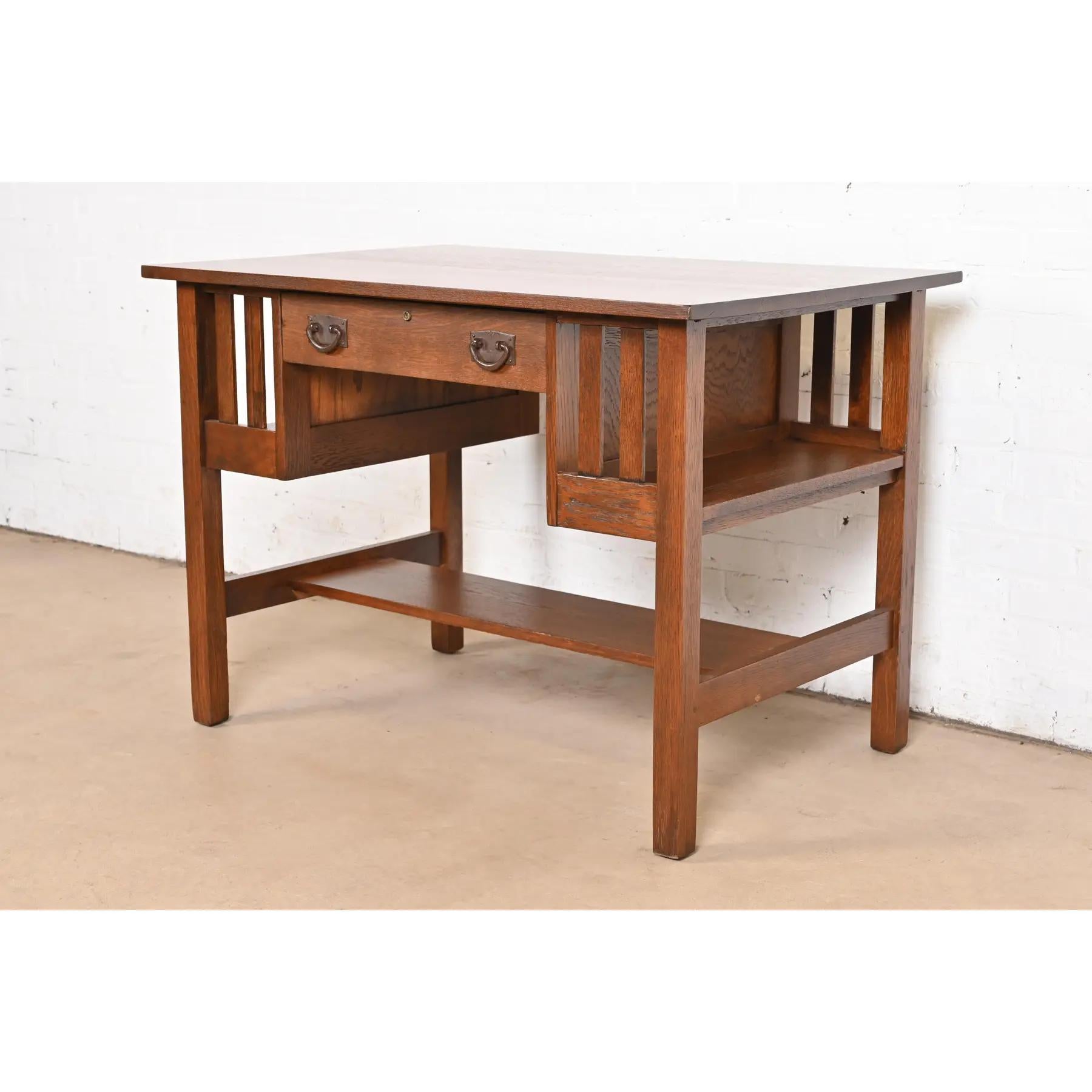 An exceptional antique Mission or Arts & Crafts writing desk or library table with built-in bookcases

By Gustav Stickley

USA, Circa 1910

Quarter sawn oak, with original hammered copper hardware.

Measures: 42