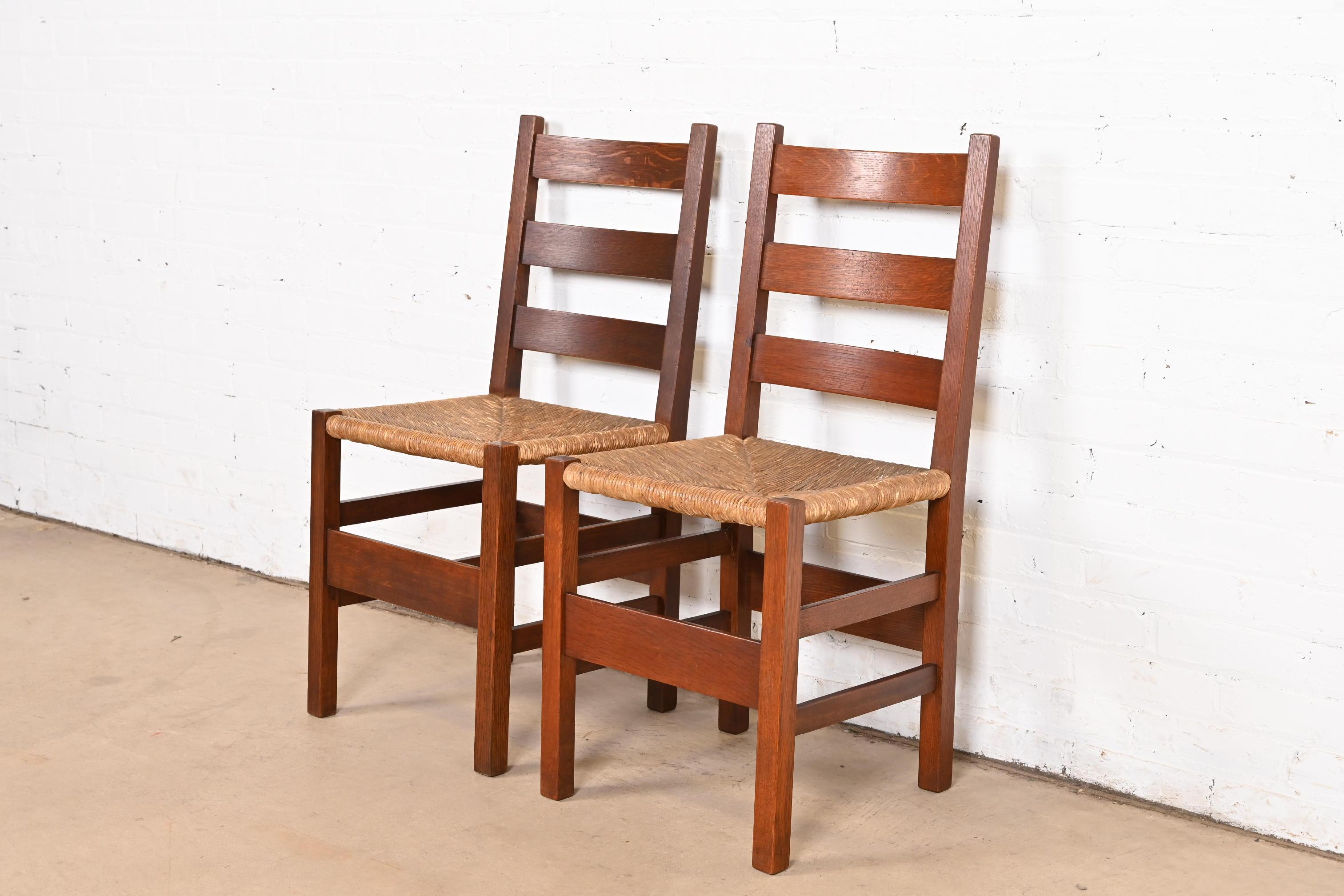 An exceptional pair of Mission or Arts & Crafts dining chairs or side chairs

By Gustav Stickley

USA, Early 20th Century

Solid quarter sawn oak, with rush seats.

Measures: 16