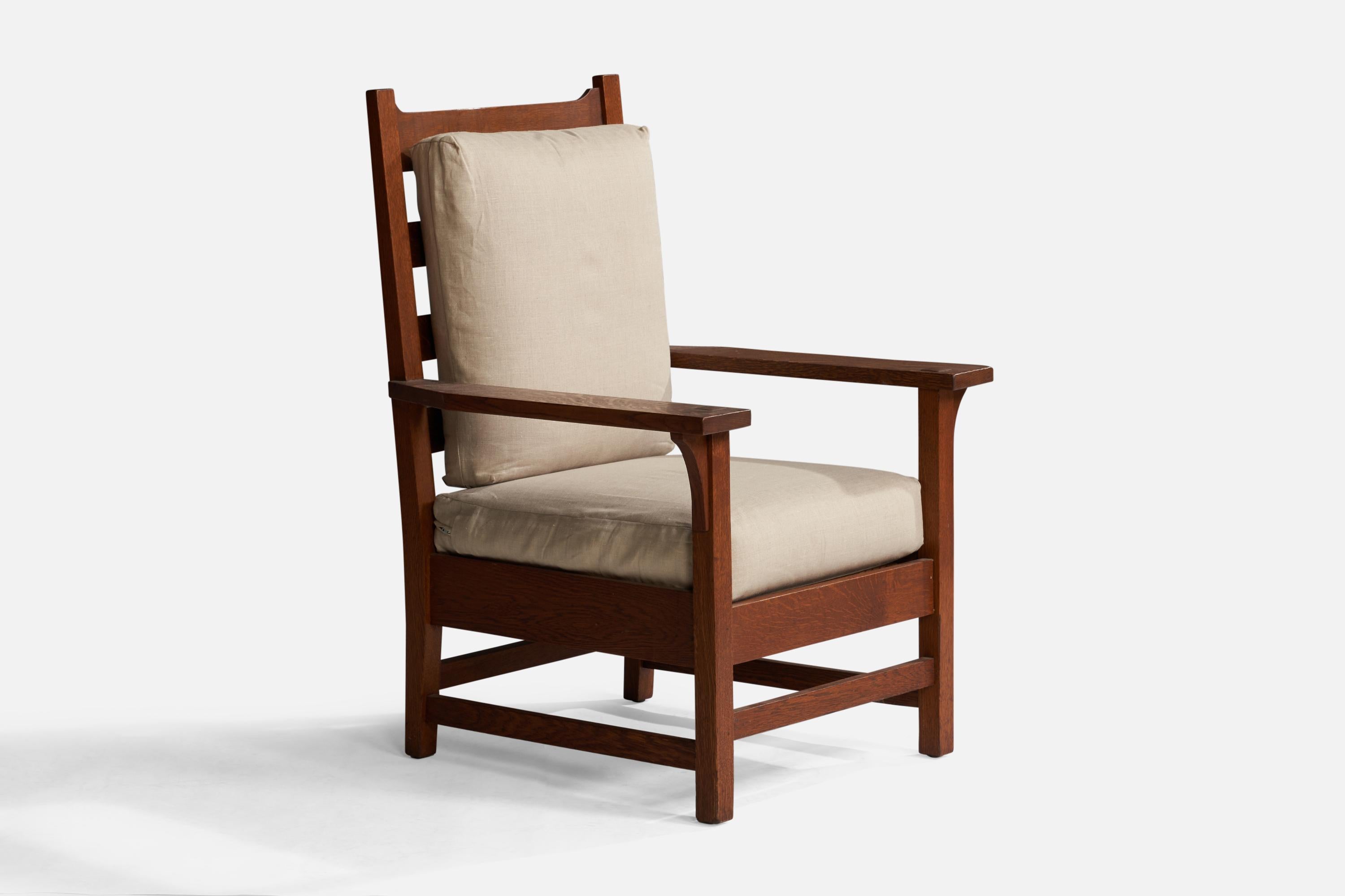 A stained oak and beige canvas armchair designed and produced by Gustav Stickley, USA, c. 1907

Seat height: 19.25