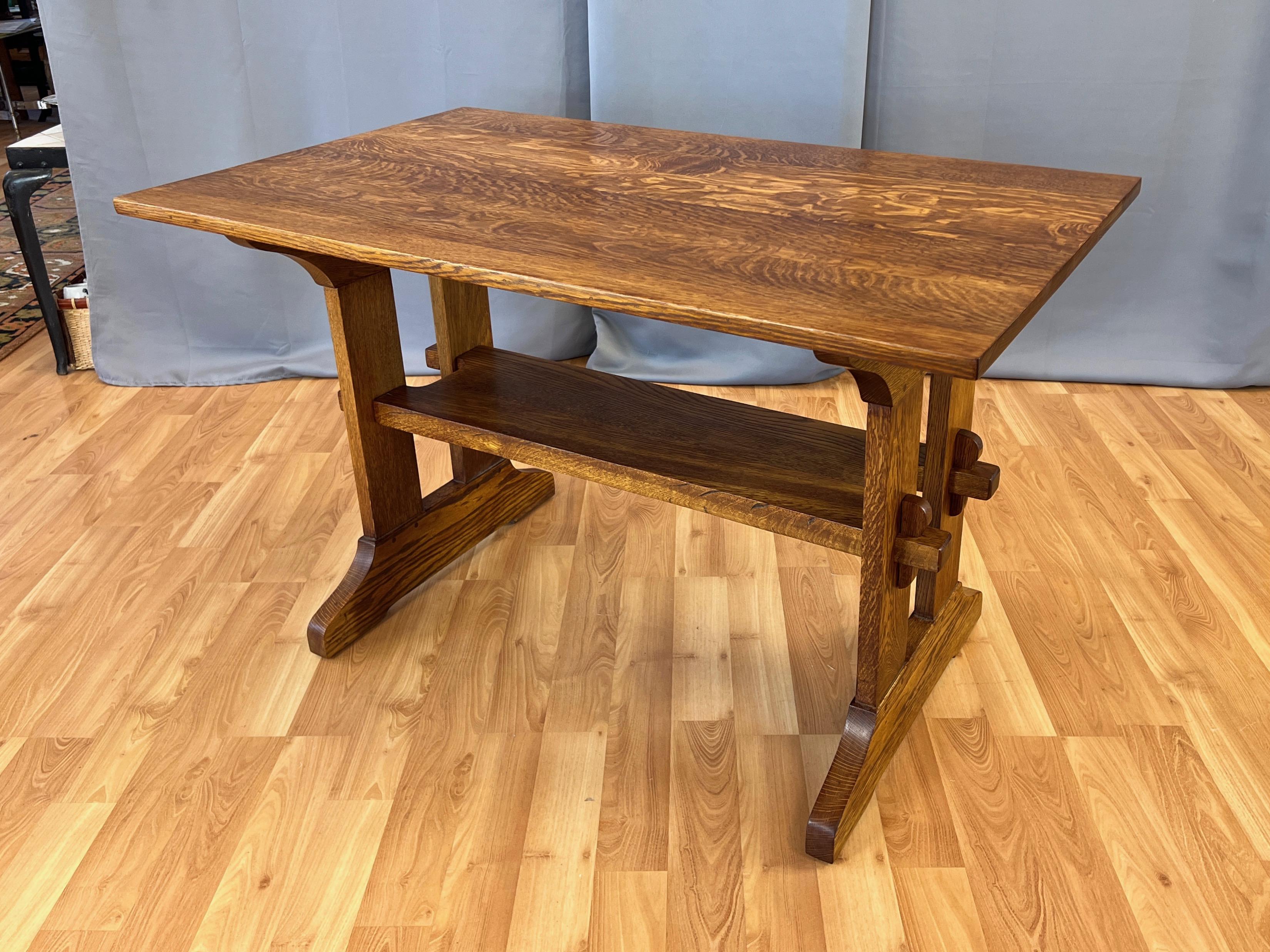 An exceptionally handsome circa 1910 Gustav Stickley Arts and Crafts movement Mission-style oak trestle table.

Originally designed as a writing desk or library table, it could also now serve as a modestly-sized dining table. Features thick